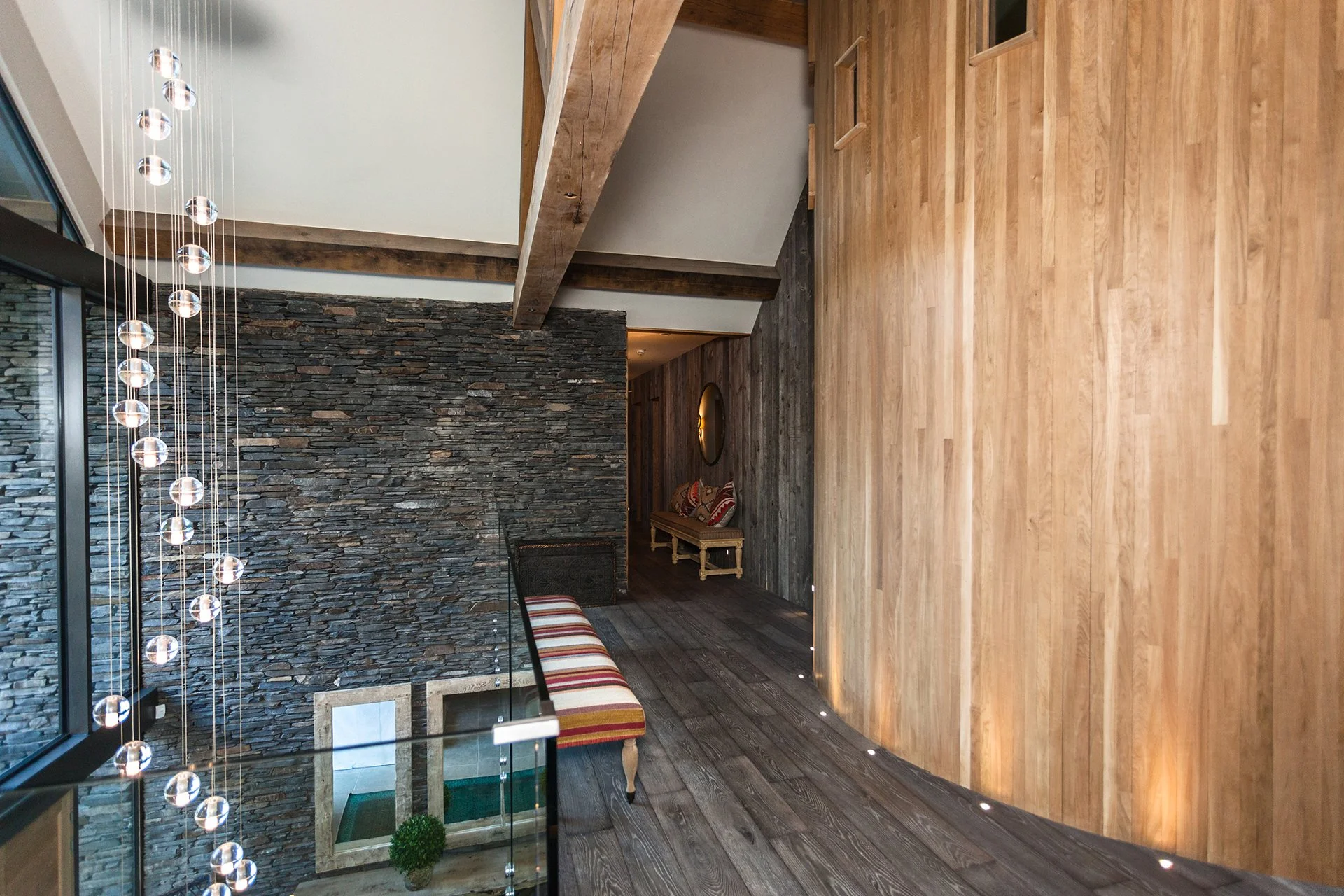 A glass and stainless-steel staircase leads up to the bedrooms all with floor-to-ceiling windows – two have oval baths overlooking the lake, for the ultimate relaxing soak.