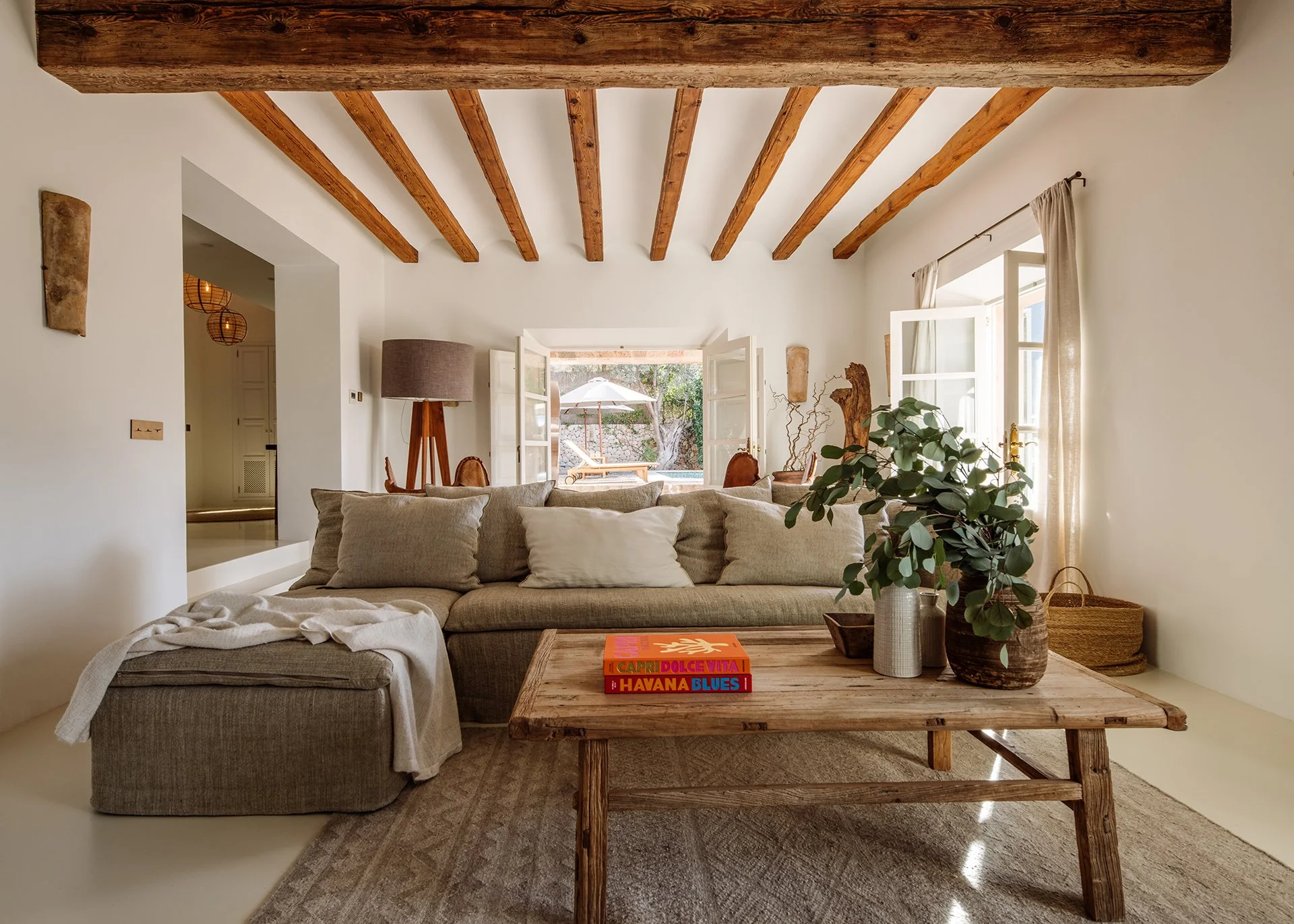 Subtle neutral tones and designer pieces by Roche Bobois, Ralph Lauren, Decorus, Cherner Chair Company and Maxalto. Relaxed, comfy seating and magnificent vaulted beamed ceiling. Stelle chandelier by Barcelona Design casting an impressive glow over t