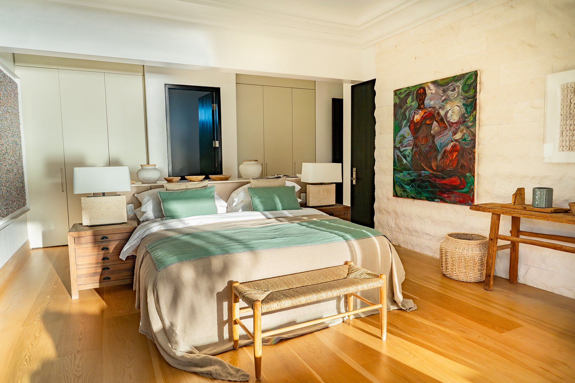 A double staircase with feature Verpan seashell chandelier leads upstairs to five spacious en suite bedrooms, some with four-poster beds; all with American oak flooring, Ralph Lauren bed stools and other unique design pieces.