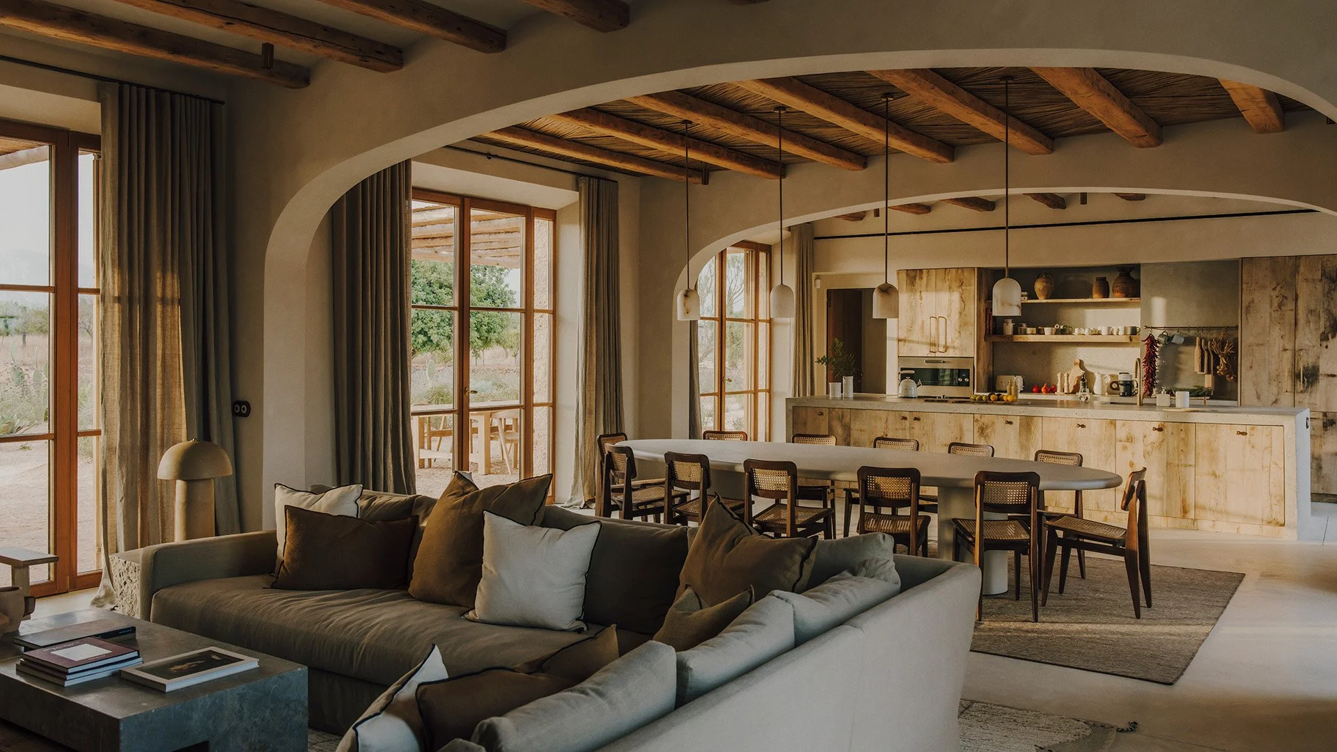 Subtle neutral tones and designer pieces adorn this relaxing living area with bespoke 2-way stone fireplace, both with relaxed, comfy seating and magnificent vaulted beamed ceiling.