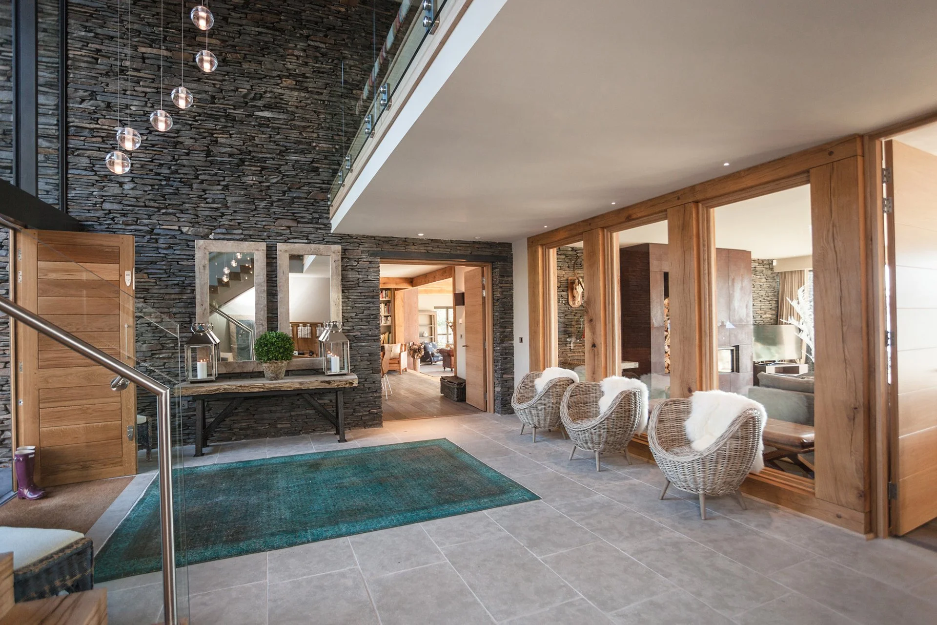 A glass and stainless-steel staircase leads up to the bedrooms all with floor-to-ceiling windows – two have oval baths overlooking the lake, for the ultimate relaxing soak.