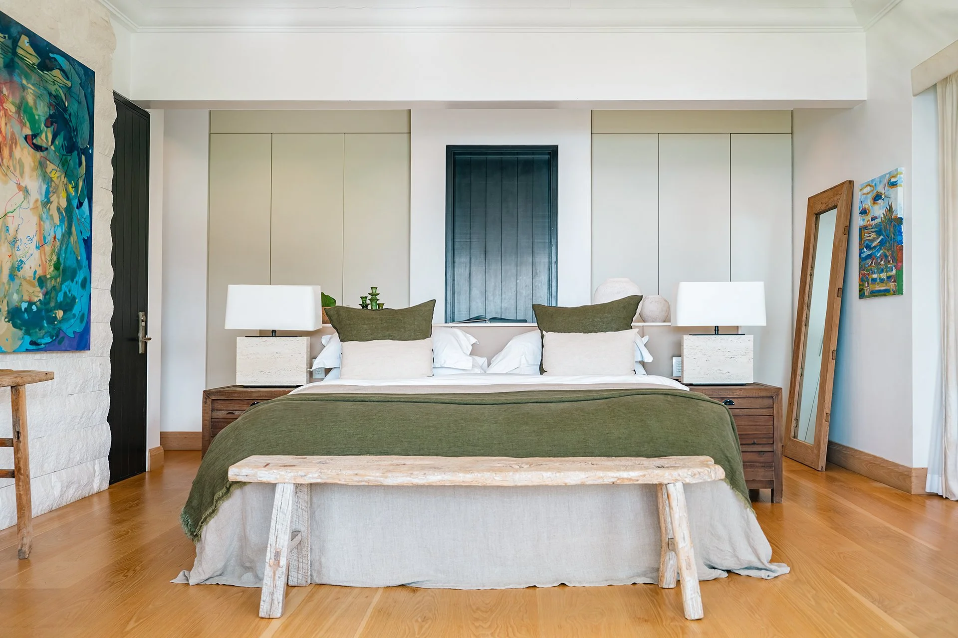 A double staircase with feature Verpan seashell chandelier leads upstairs to five spacious en suite bedrooms, some with four-poster beds; all with American oak flooring, Ralph Lauren bed stools and other unique design pieces.