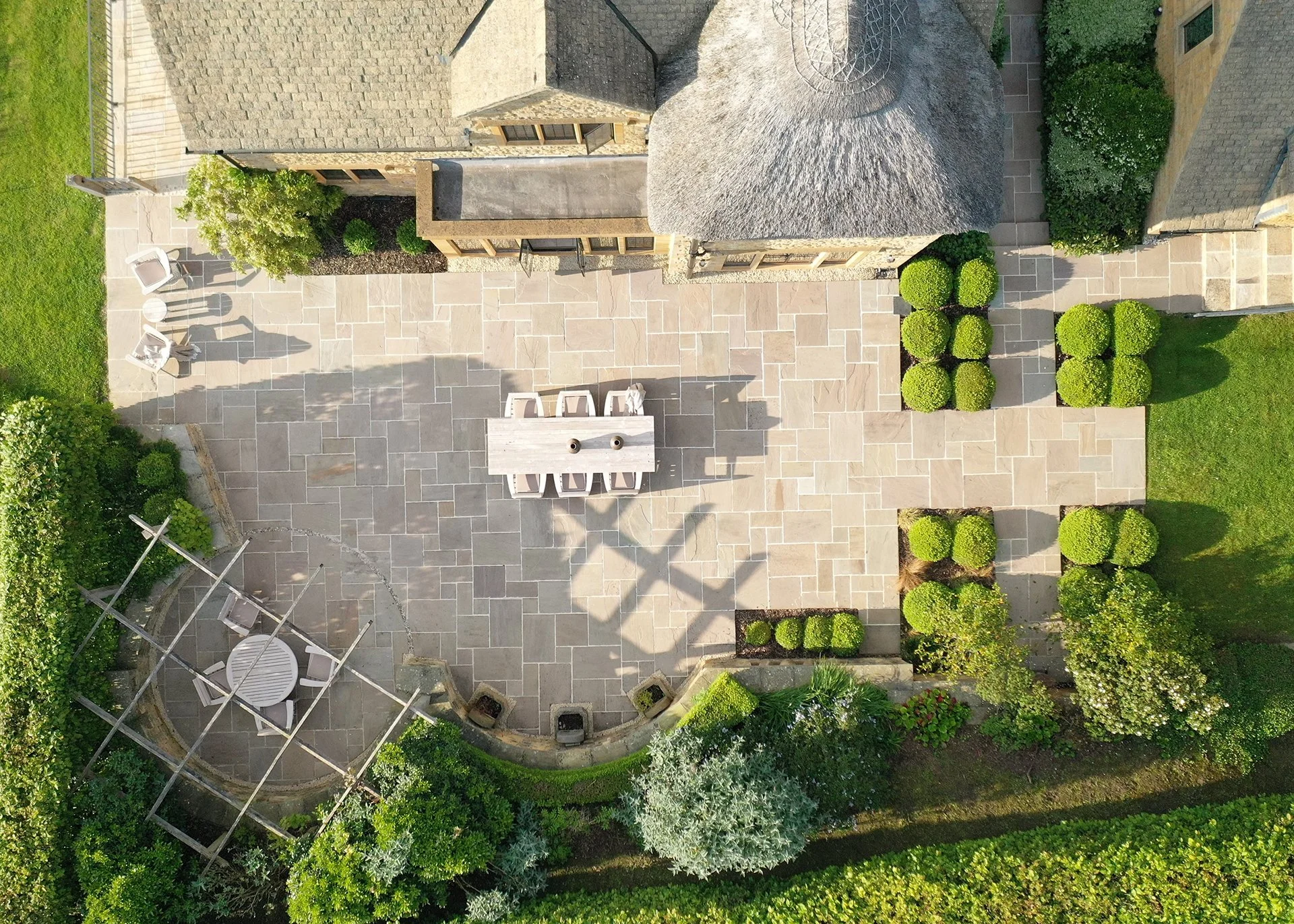 Large landscaped gardens feature a decorative ha-ha and sunny upper terrace.
Another terrace adjacent to the kitchen with built-in seating, table and a BBQ is perfect for al fresco dining.