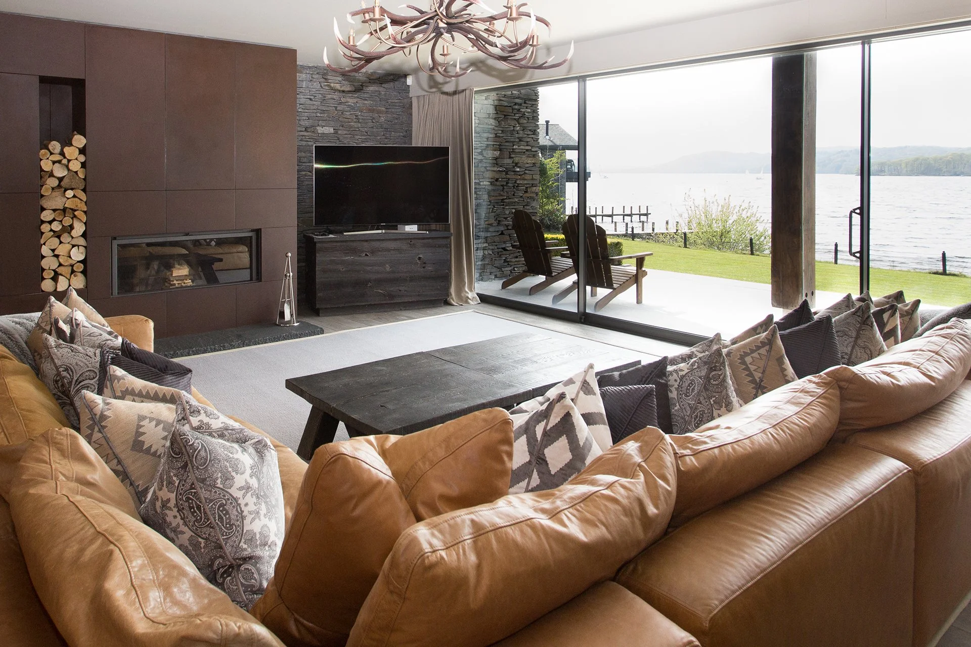 The spacious, open-plan living area features a high-spec kitchen, impressive dining table and living area with Stuv woodburner faced with local Burlington Stone. The main lounge with woodburner and additional snug are ideal for cosy nights in.