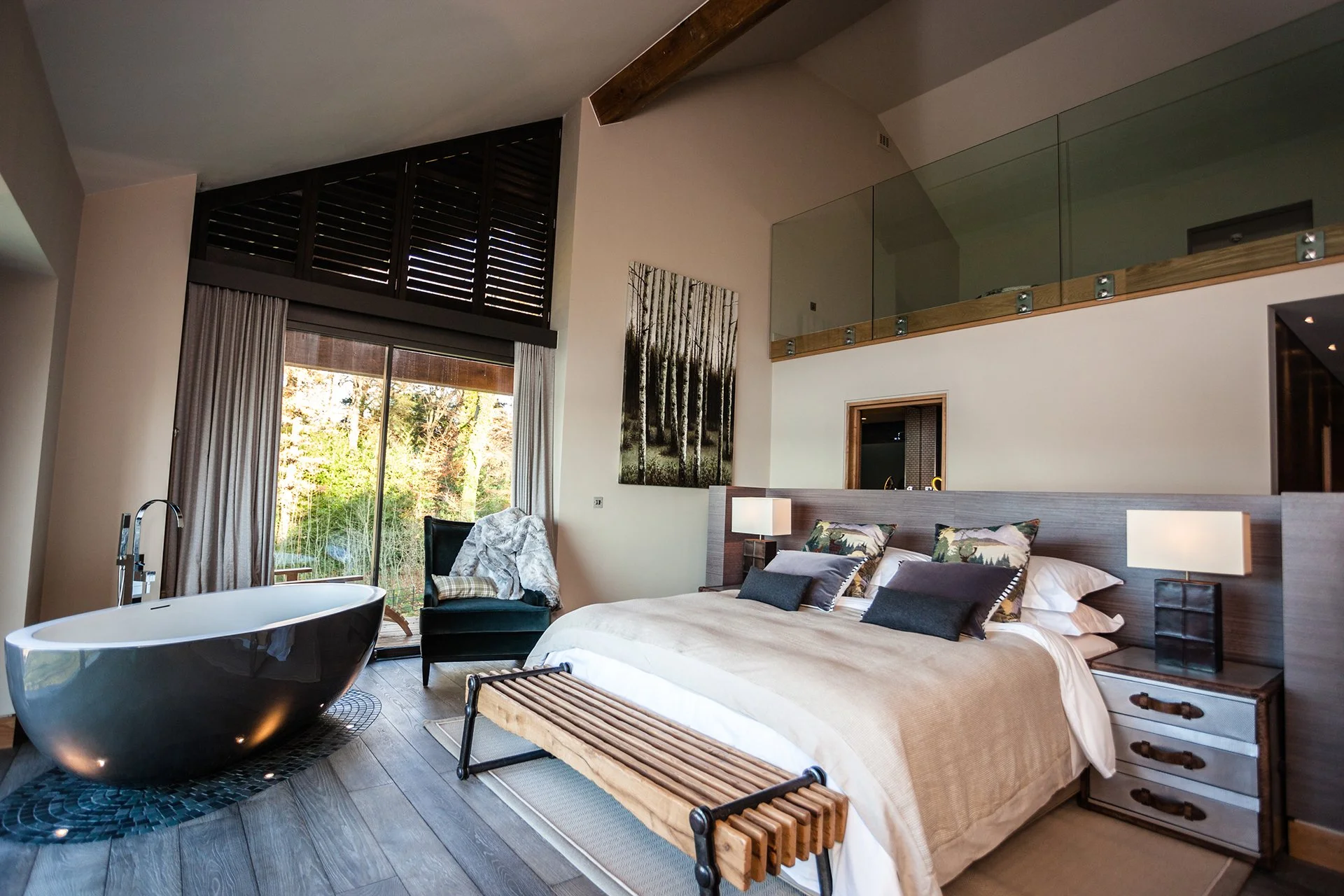 A bespoke glass and stainless steel staircase leads to five en-suite bedrooms with floor-to-ceiling windows, four of which have uninterrupted lake views three have balconies. Each has a ViSpring bed, two of which can be made up as twins. Two bedrooms