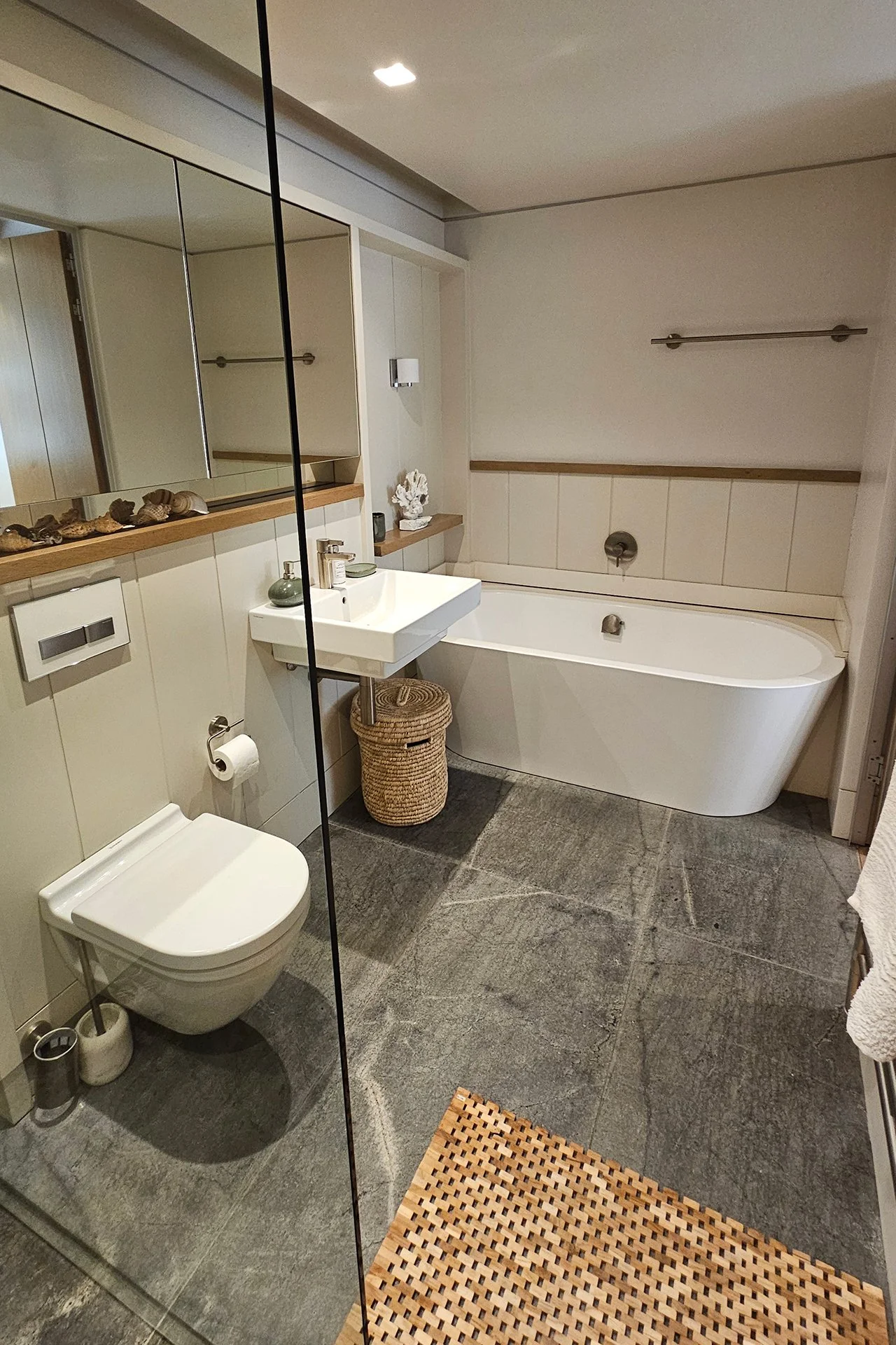 The master bedroom has a spacious bathroom with two sinks, shower and contemporary freestanding oval bath. One guest room has a bathroom with shower and contemporary freestanding oval tub; the other has a shower room.