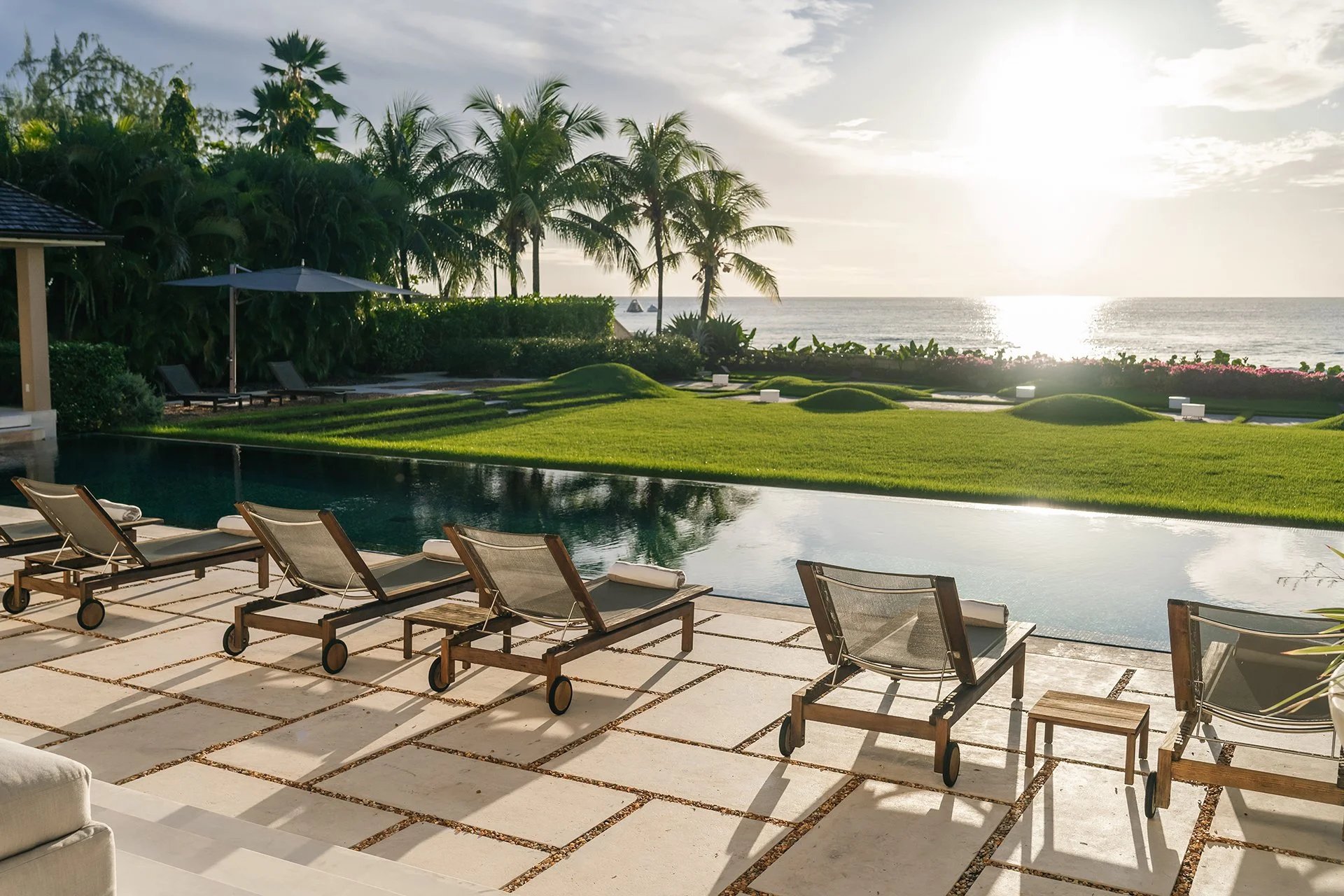 The sleek 25m mosaic-lined pool surrounded by limestone tiles and comfy sun loungers...
Around 1.2 acres of landscaped gardens with palm trees, scented shrubs and a spice garden.