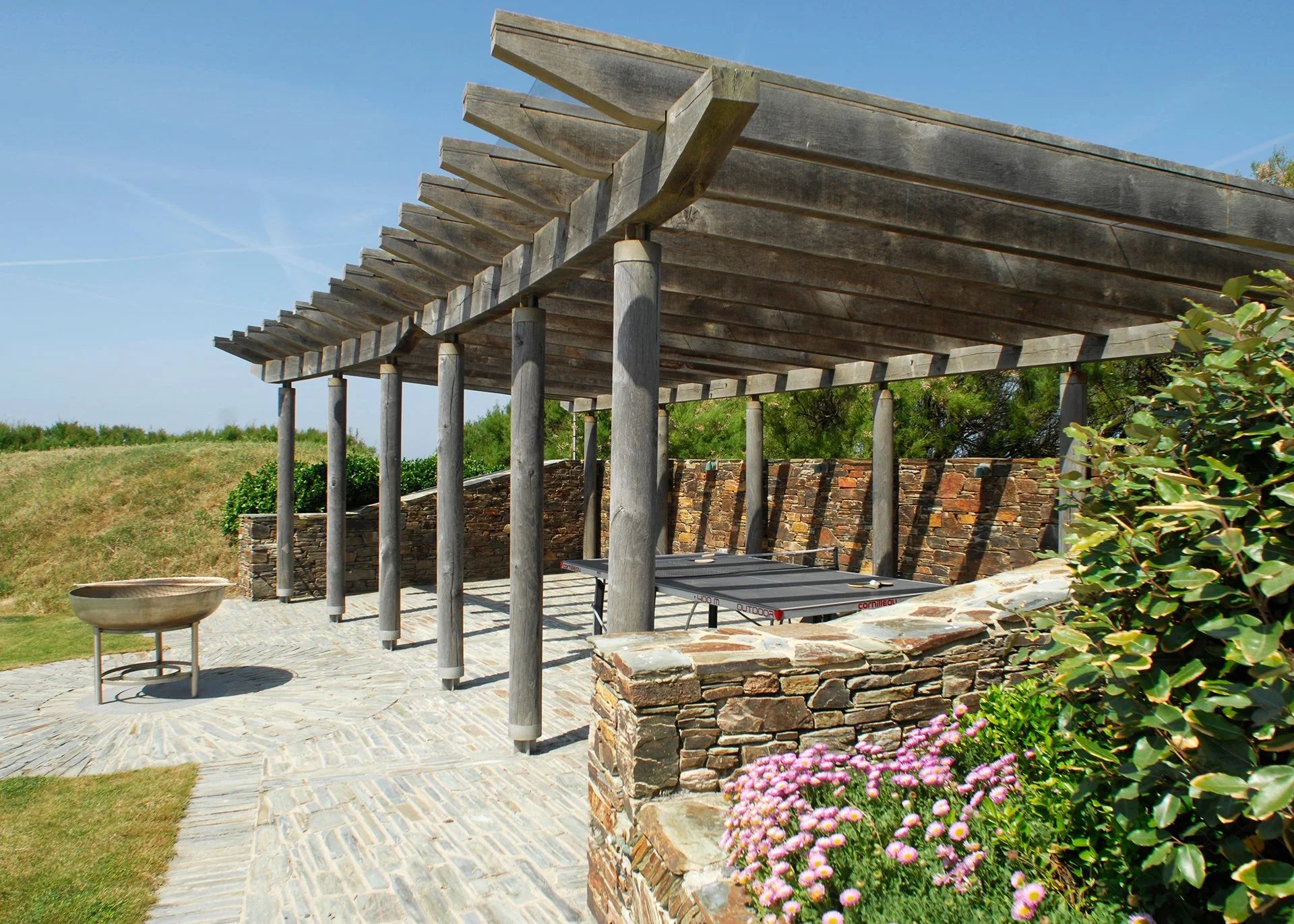 Outside, an acre of garden includes a terrace with sun loungers and a BBQ area. A gate gives direct access to the South West Coastal Path and the beach.