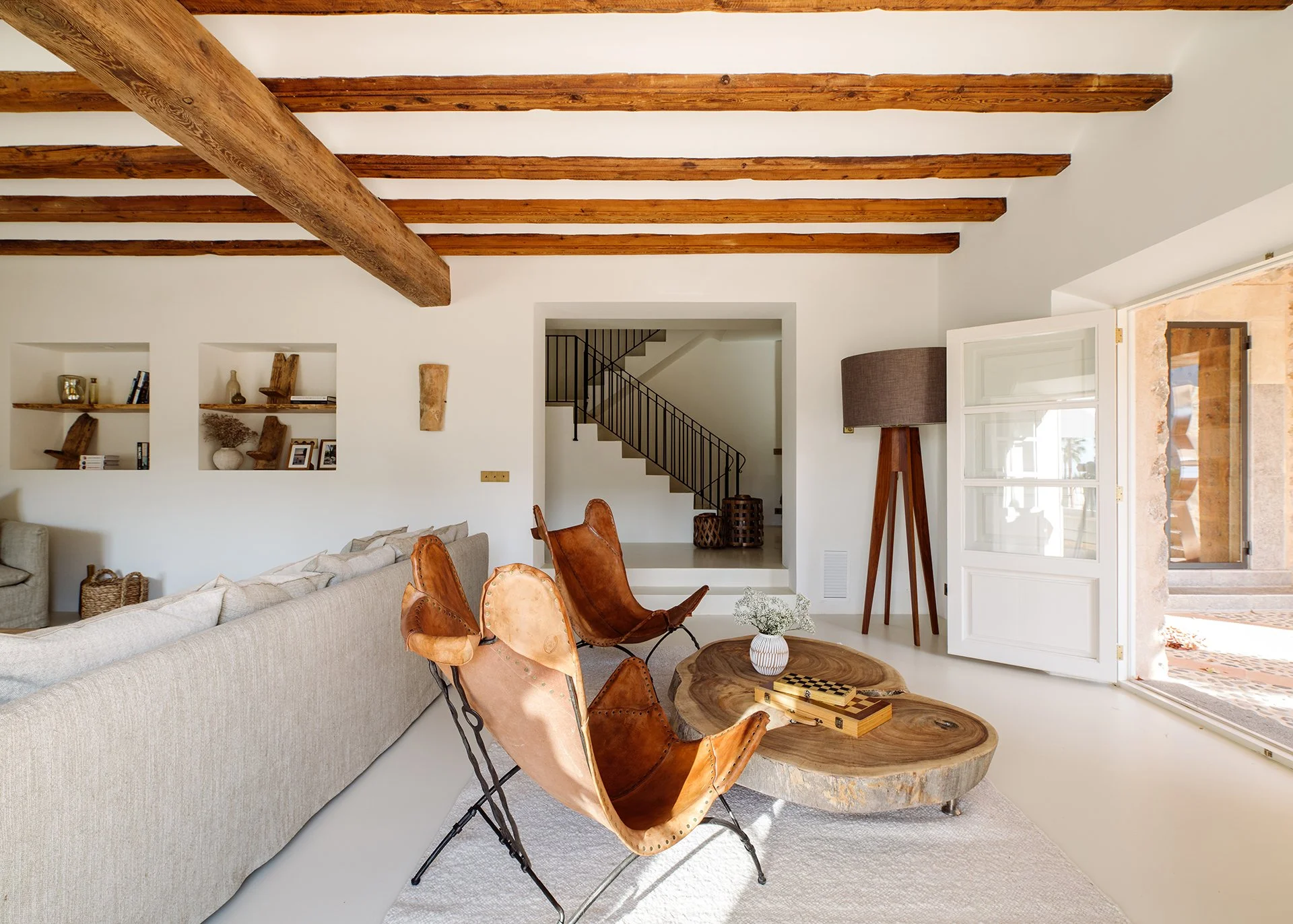 Subtle neutral tones and designer pieces by Roche Bobois, Ralph Lauren, Decorus, Cherner Chair Company and Maxalto. Relaxed, comfy seating and magnificent vaulted beamed ceiling. Stelle chandelier by Barcelona Design casting an impressive glow over t