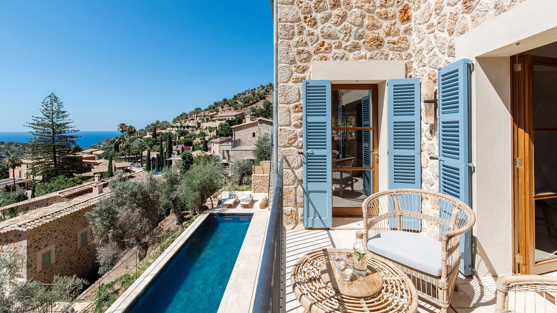 The stunning house offers a seamless fusion of traditional architecture and contemporary design, coupled with panoramic views of the village and ocean beyond. Book a month-long stay at Sa Milana, Deià. 
