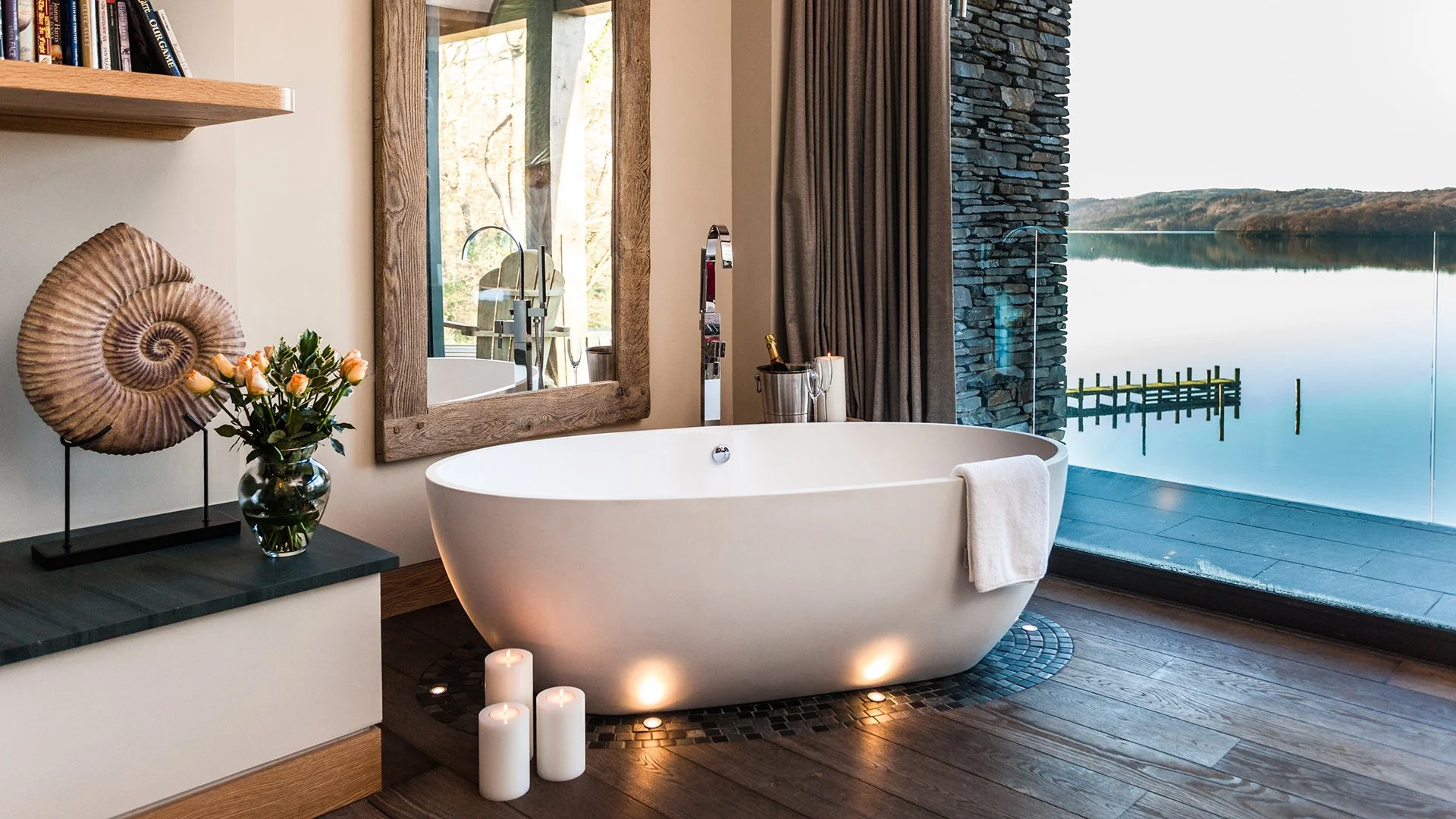 Two bedrooms have oval baths overlooking Lake Windermere with the backdrop of stunning views of Lake Windermere for a nature-immersed ambience. Book Grey Gables now and escape to luxury with Simon Escapes. 