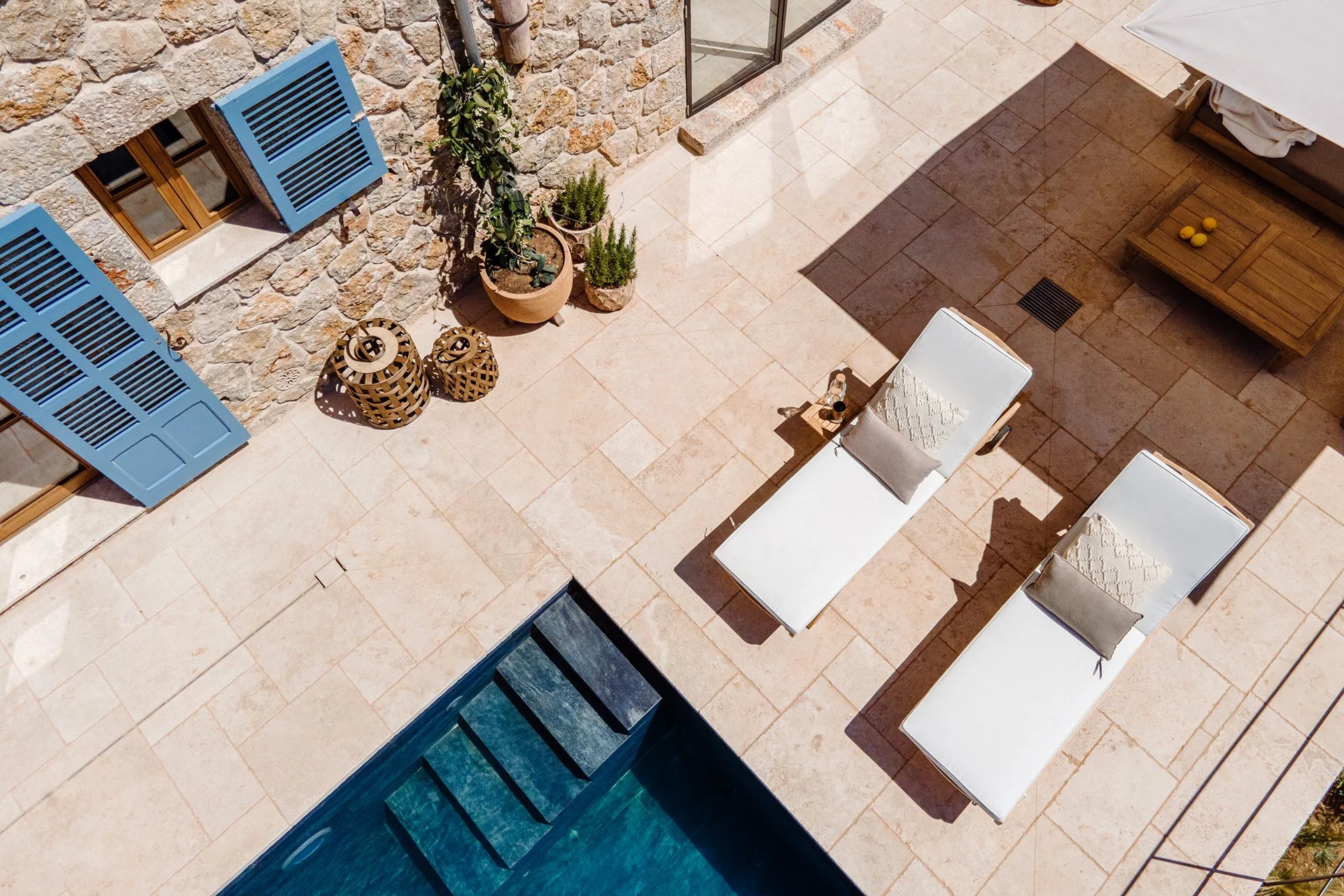 Sun loungers and comfy chairs are well placed as well as parasols. Adjacent to the pool, a covered terrace provides a cool, elegant space to unwind. Ideal for long lunches or evening cocktails with a view.