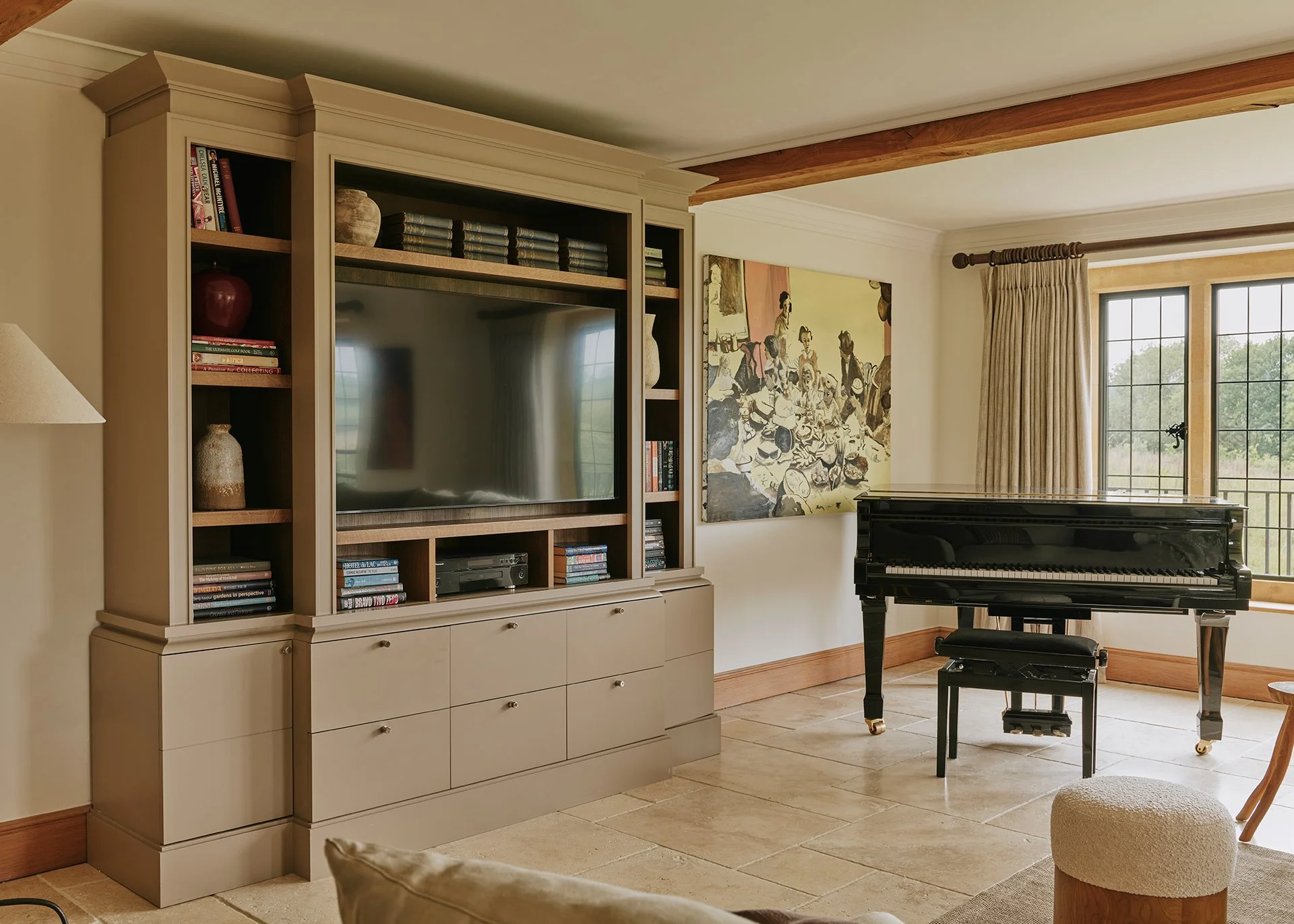 The living room is stylish and elegant, with a large woodburning stove, flagstone flooring, decadent rugs and two sumptuous sofas...
There’s also a baby grand piano - arrangements can be made for a local pianist to play for you.