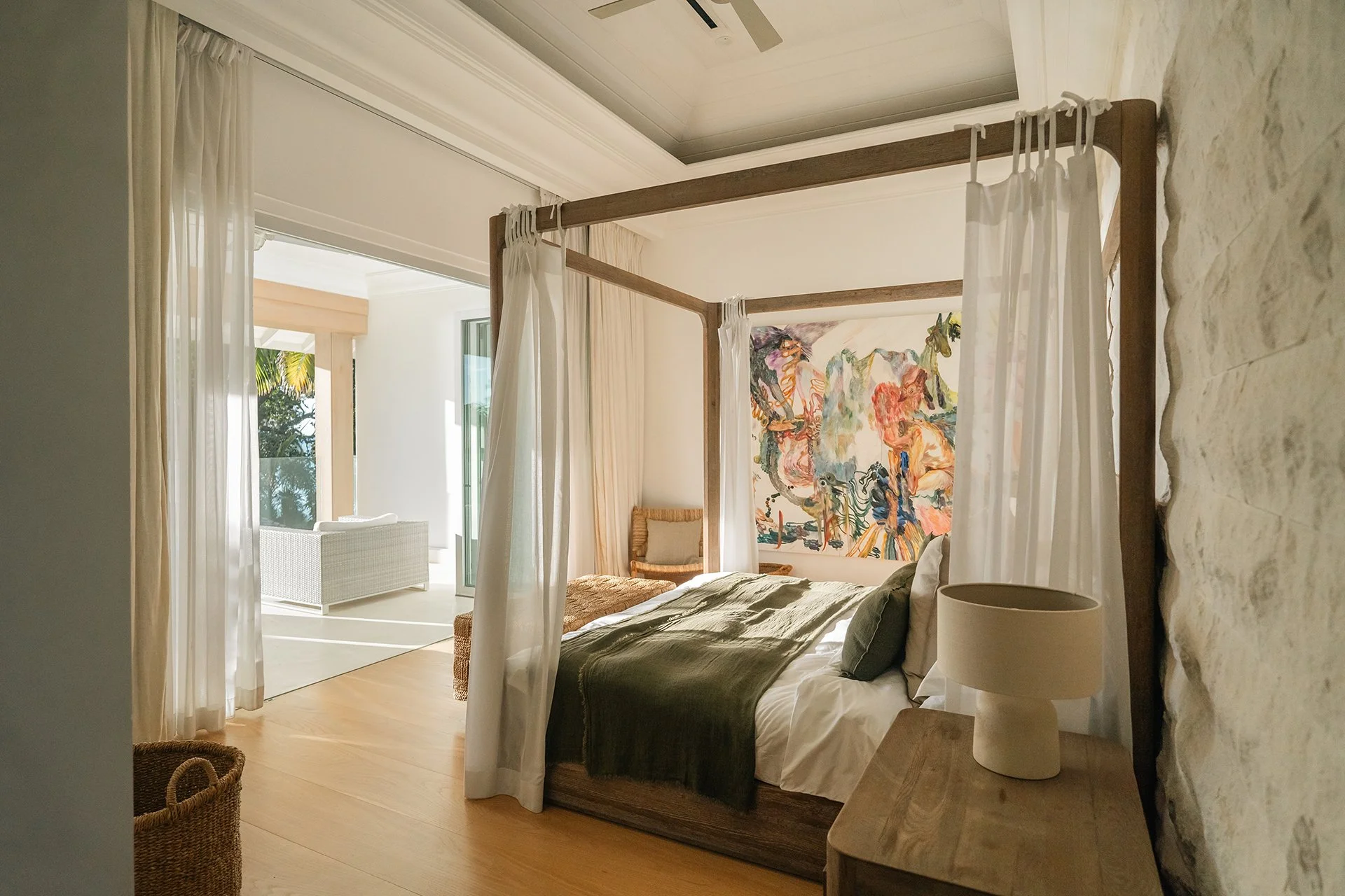 A double staircase with feature Verpan seashell chandelier leads upstairs to five spacious en suite bedrooms, some with four-poster beds; all with American oak flooring, Ralph Lauren bed stools and other unique design pieces. 