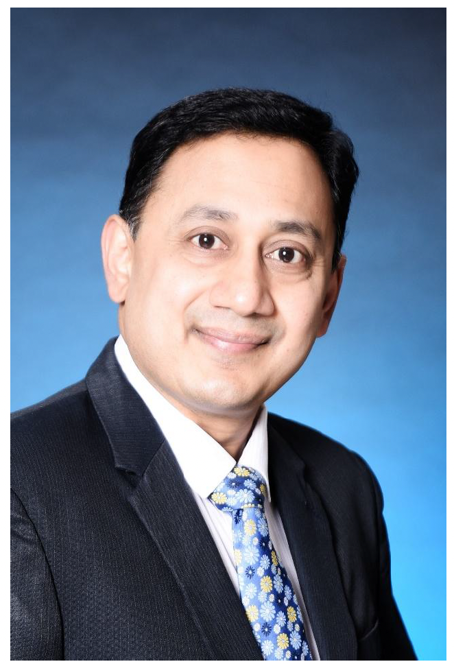 Professional headshot of a man in a suit and tie with a blue background.