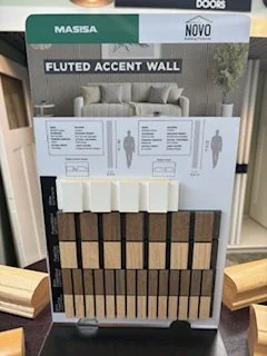 Display board showcasing different styles and colors of fluted accent wall panels for interior decor.