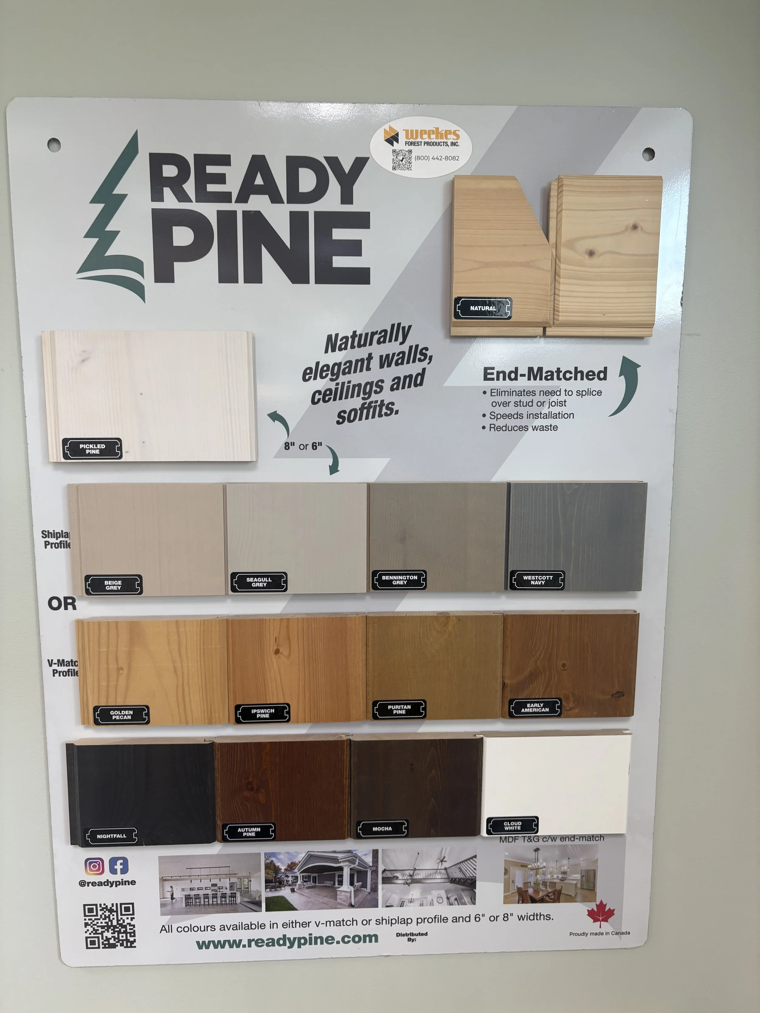 Display of pine wood samples arranged in rows, labeled with color names such as Pickled Pine, Beige Grey, Seagull Grey, Bennington Grey, Westcott Navy, Golden Pecan, Ipswich Pine, Puritan Pine, Nightfall, Autumn Pine, Mocha, and Cloud White. A sign indicates the wood is naturally finished, end-matched, and available in 6 or 8 inches widths.