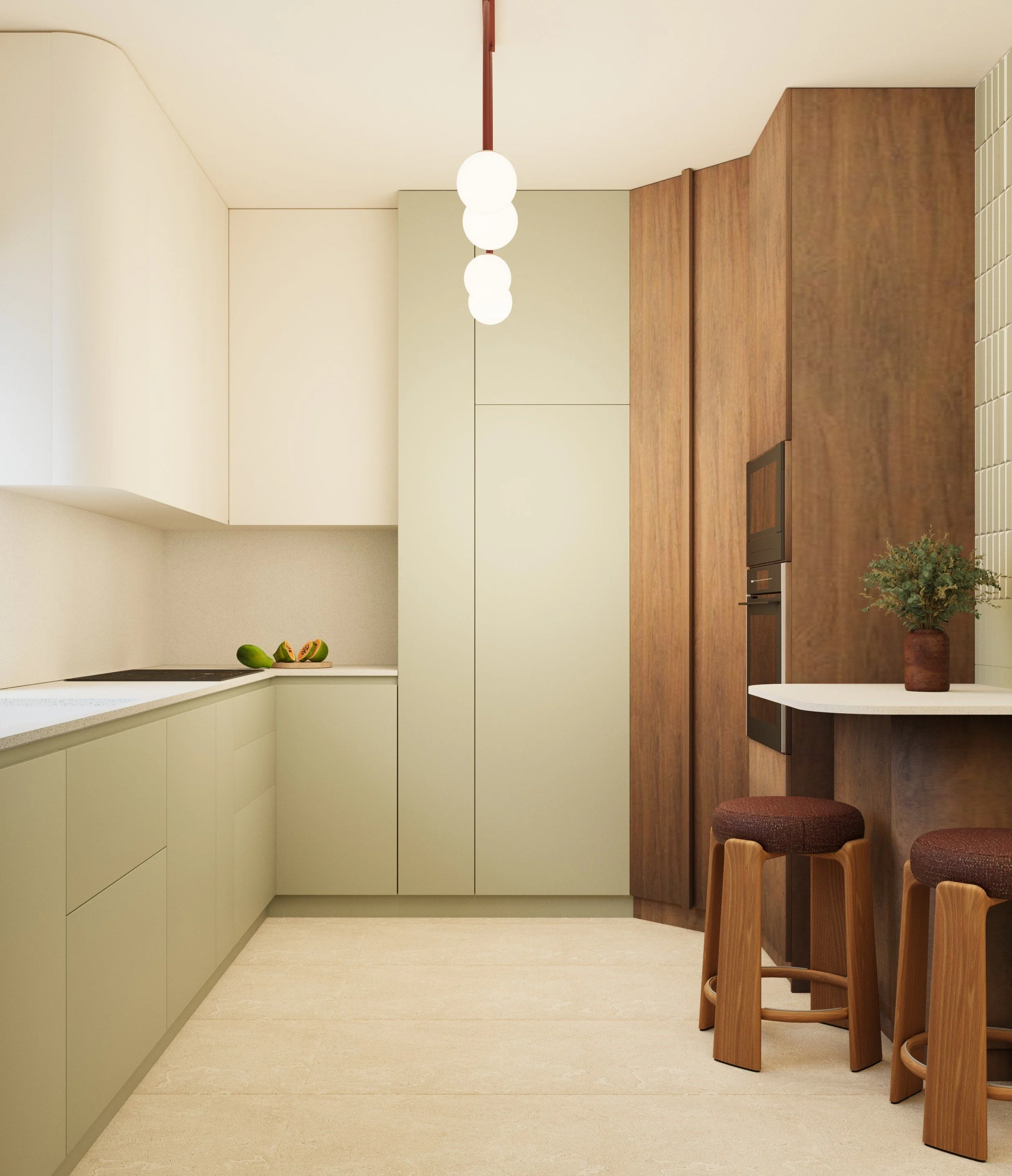 Modern kitchen with pale green cabinets, a wooden bar counter with stools, and a white wall with a plate of fruit and a potted plant.