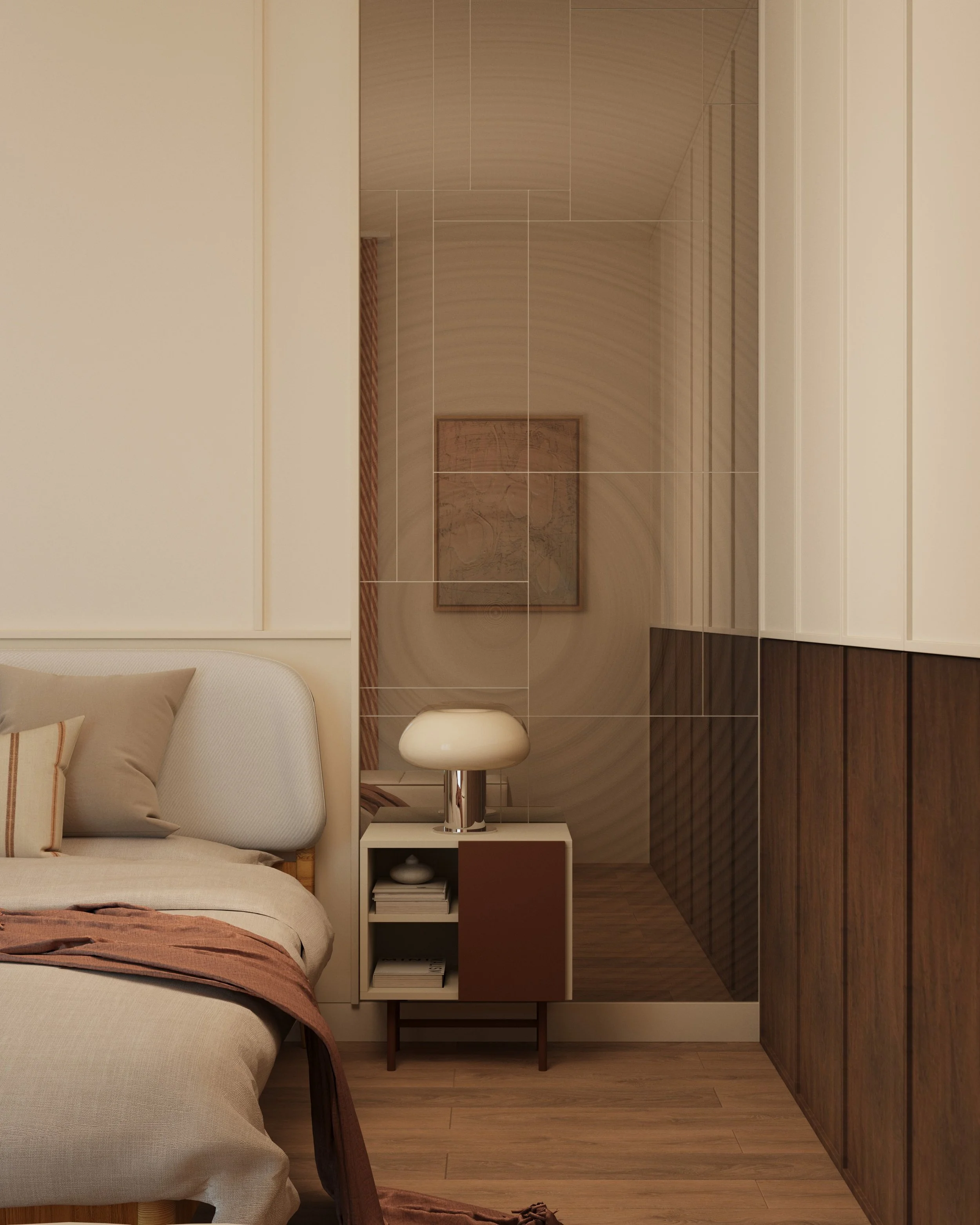 A bedroom with a bed on the left, bedside table with a lamp, and wall cabinets. The floor has wood planks, and a framed artwork hangs on the wall.