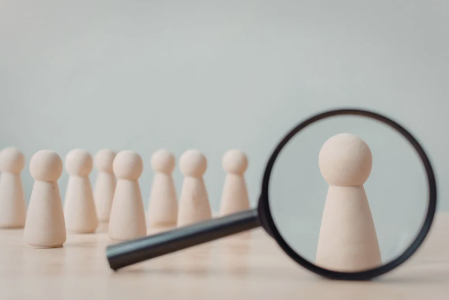 Magnifying glass over a pawn, making it stand out against others