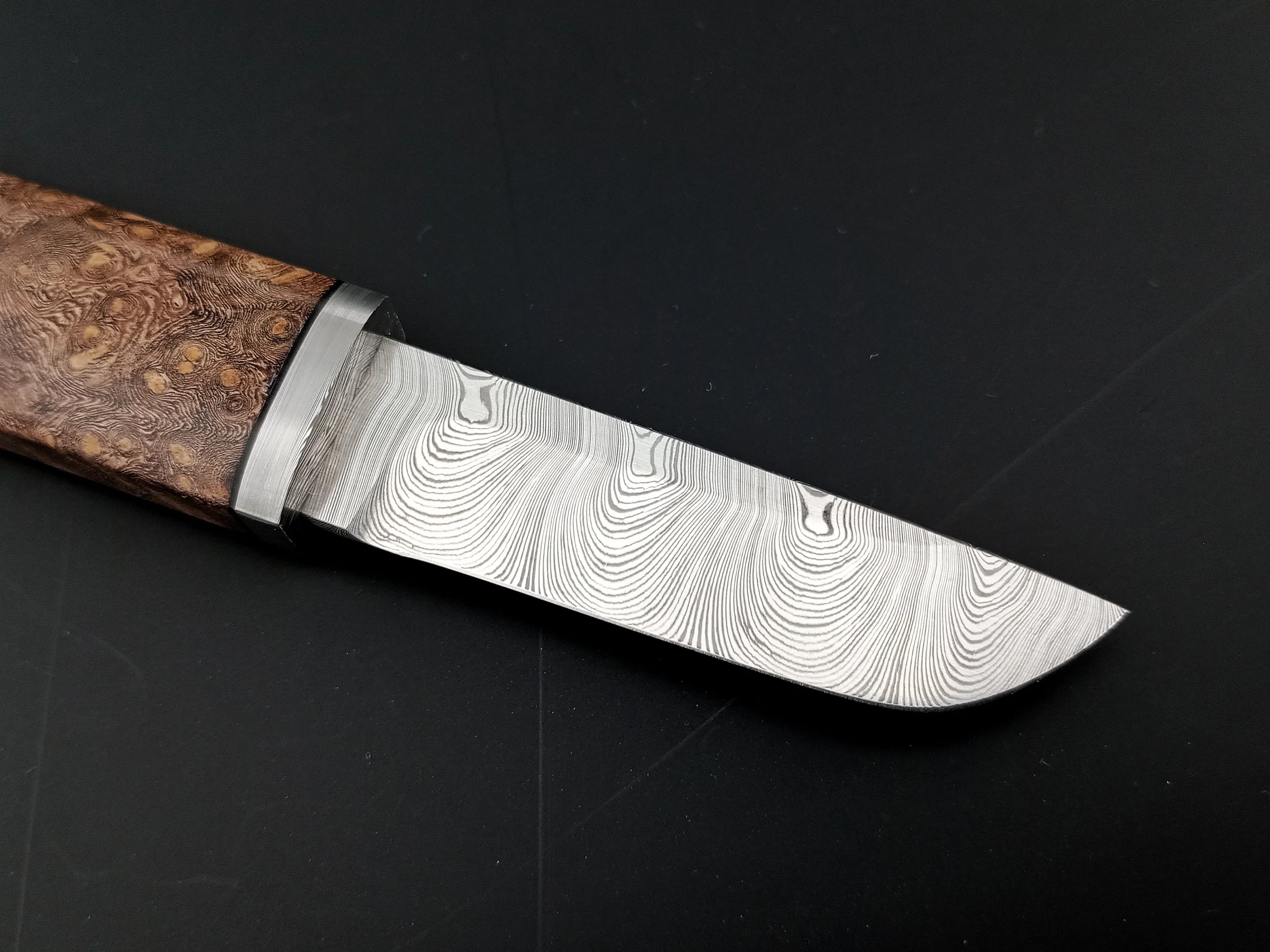 Damascus steel blade and a wooden handle.