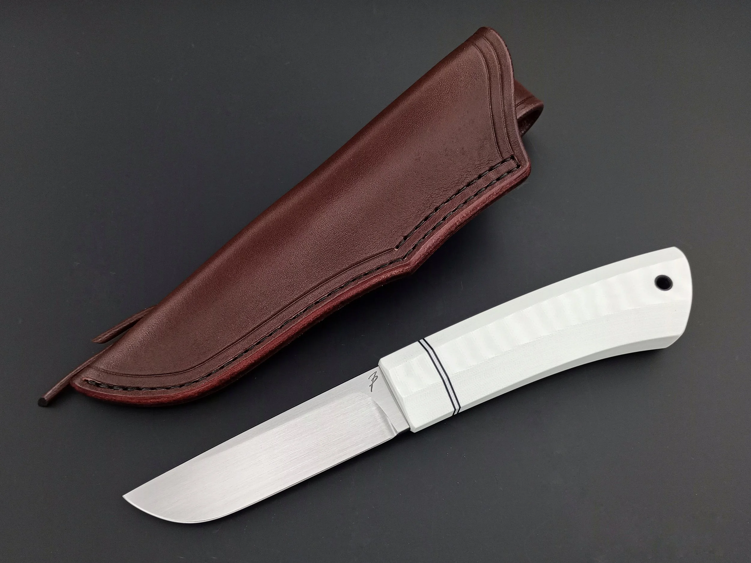 A white fixed-blade knife.