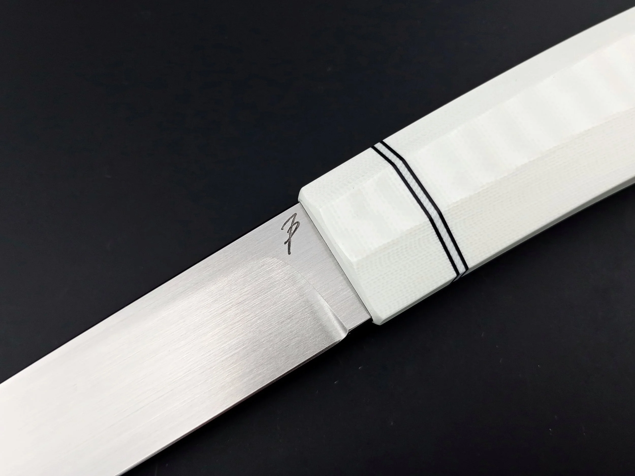 Stainless steel blade and a white handle Knife.