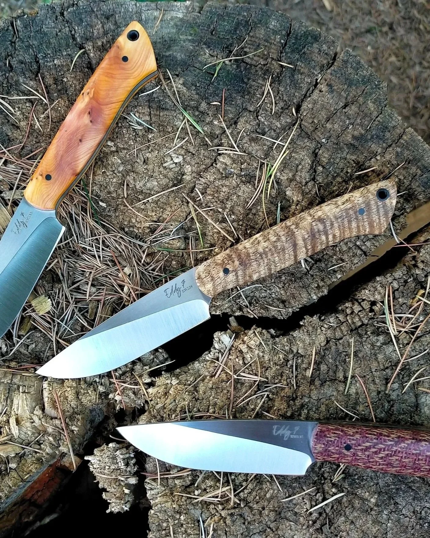 Three knives with wooden handles.