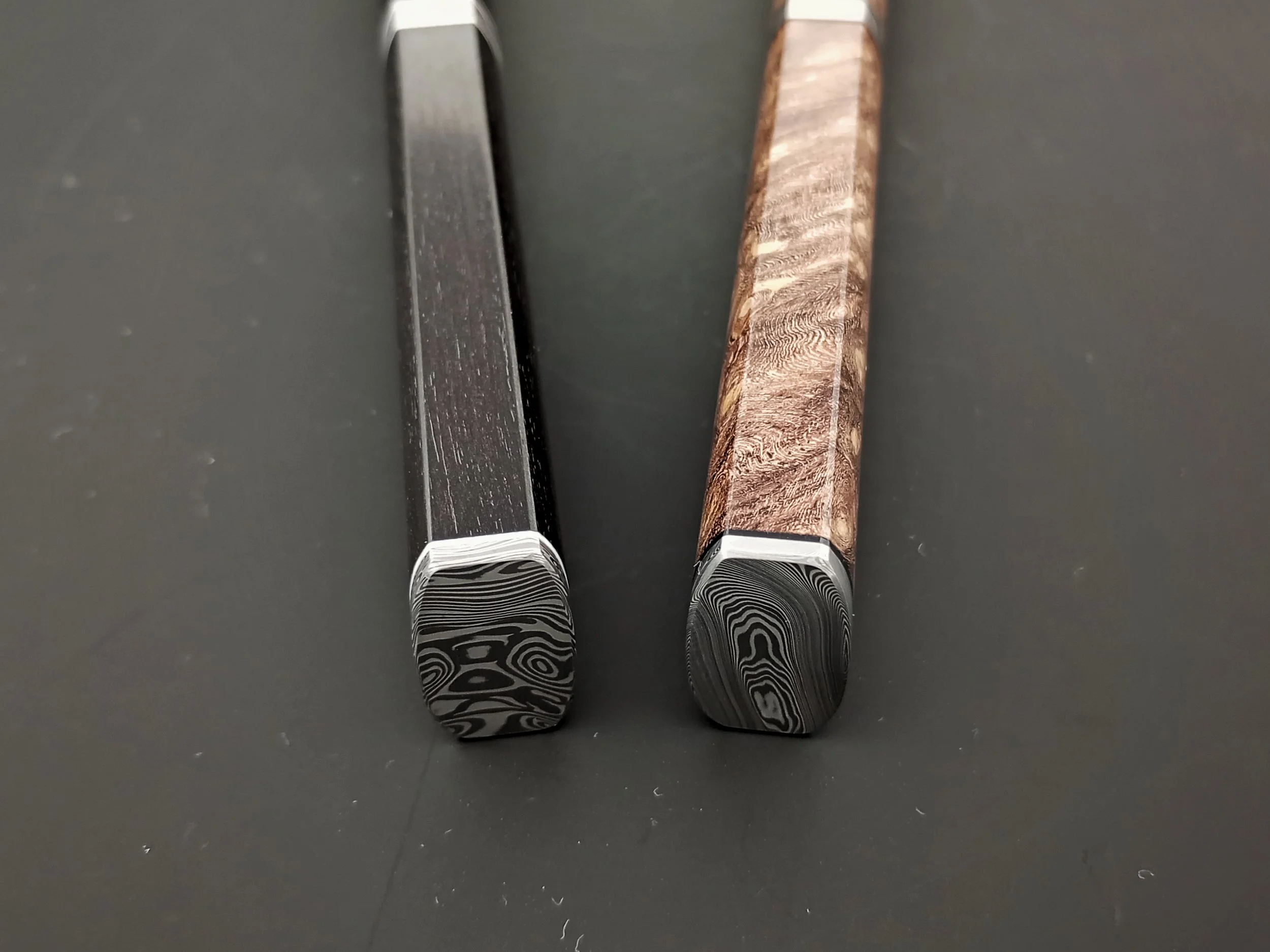 Ends of two mini knives with Damsteel.