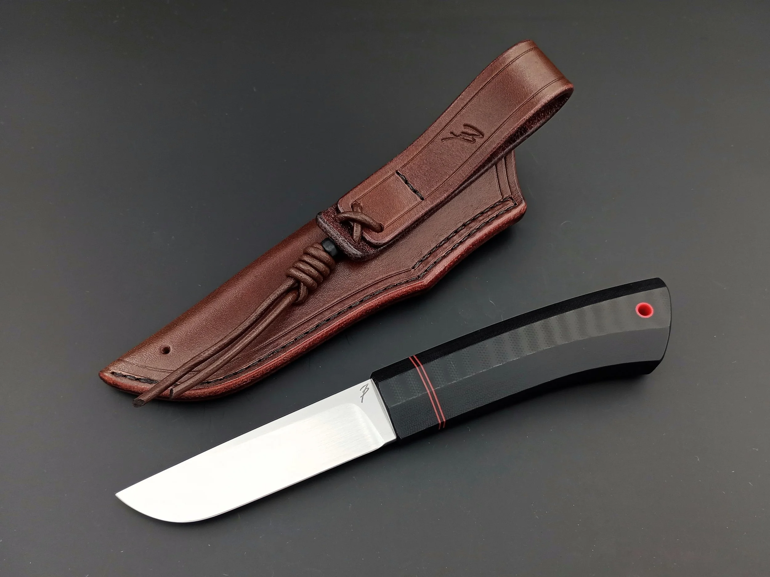 A northern knife with a black handle.