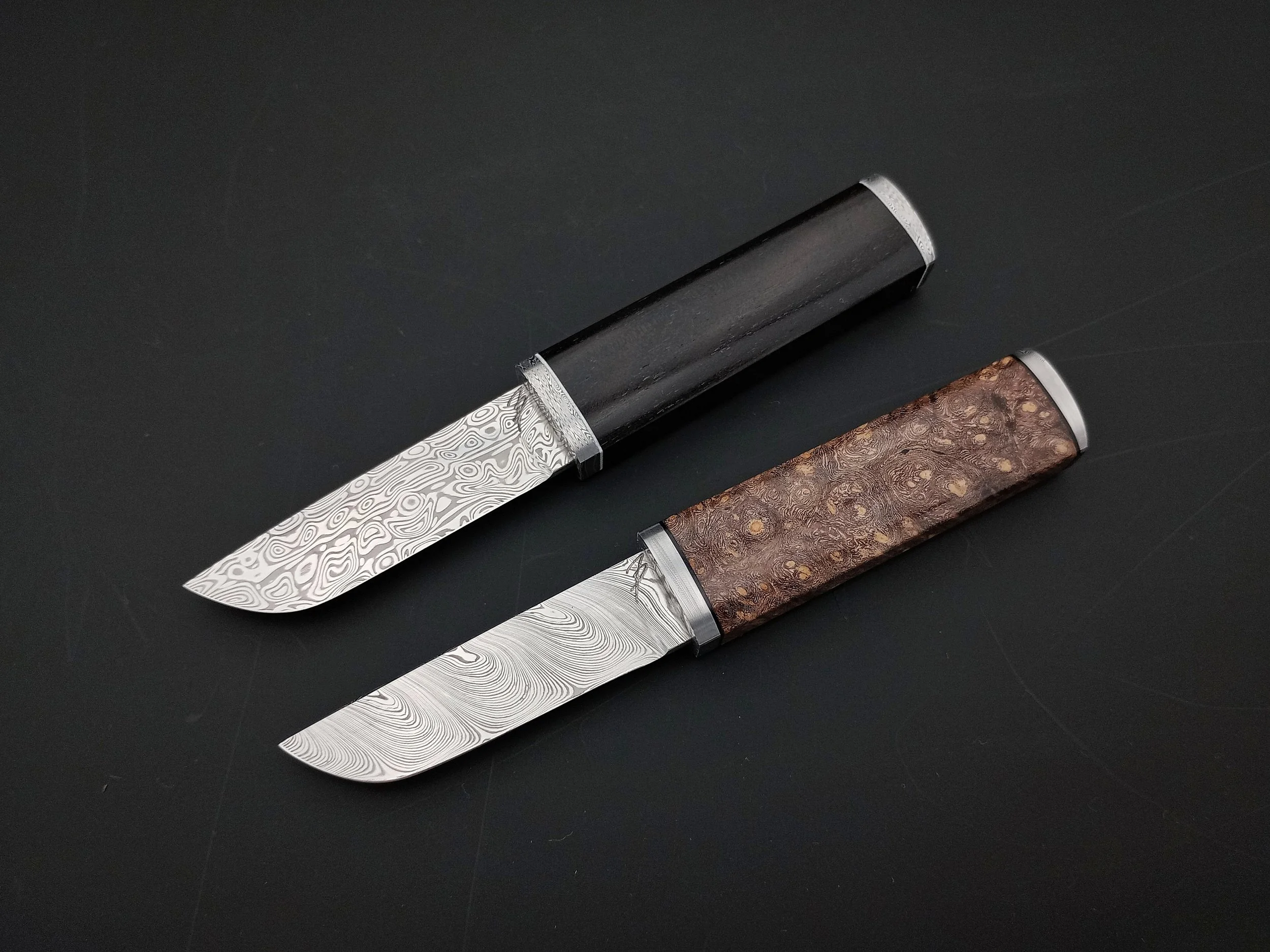 Two Damasteel mini northern knives.