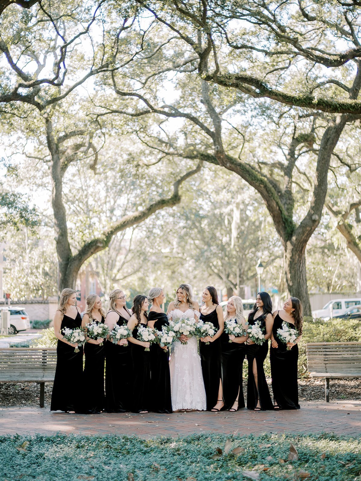 black bridesmaids dresses with white bouquets