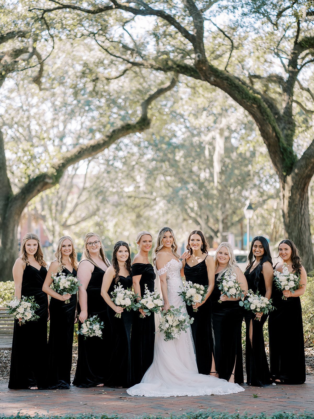 black modern bridesmaids dresses and ivory bouquets
