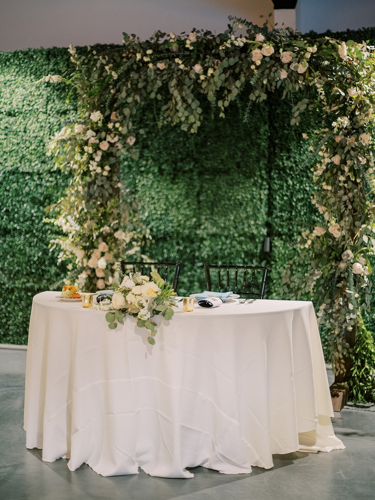 organic modern white sweetheart table with lush florals
