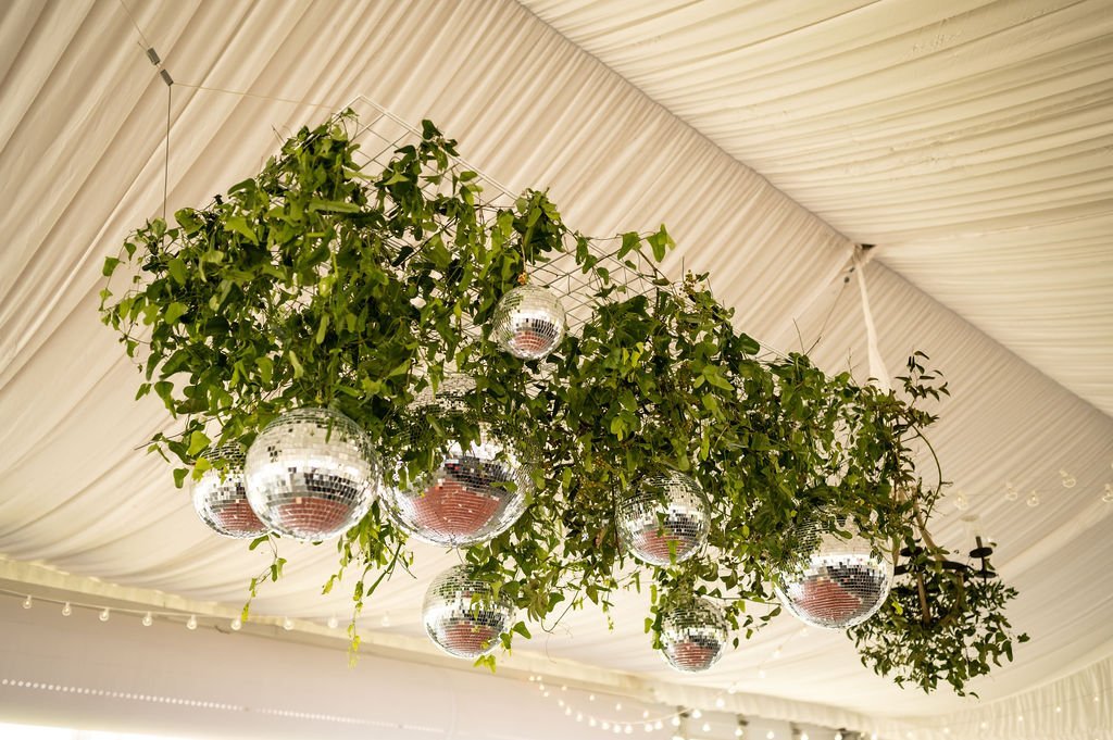 hanging installment with greenery and disco balls