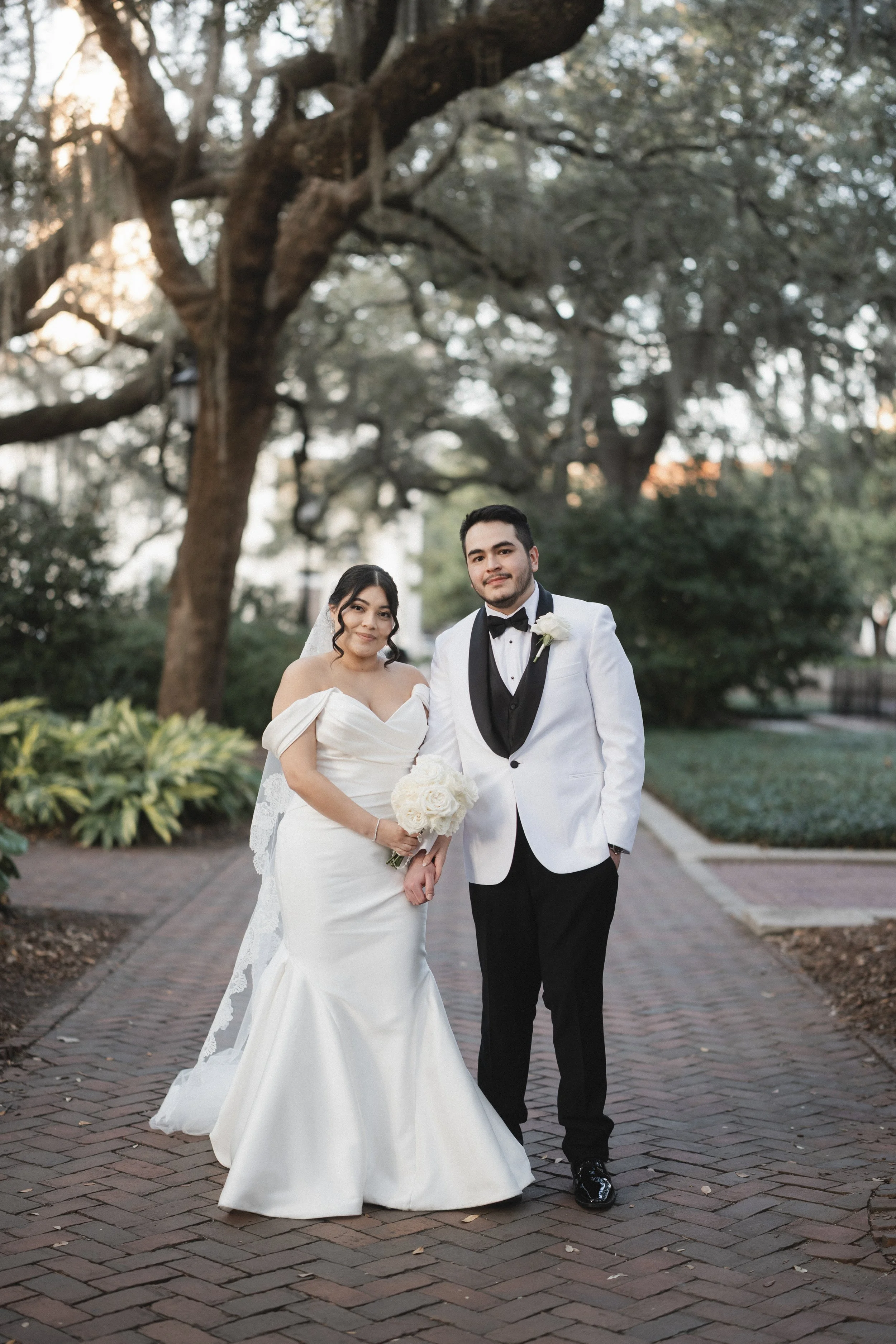 Classic Outdoor Wedding Portrait with White Tuxedo Groom