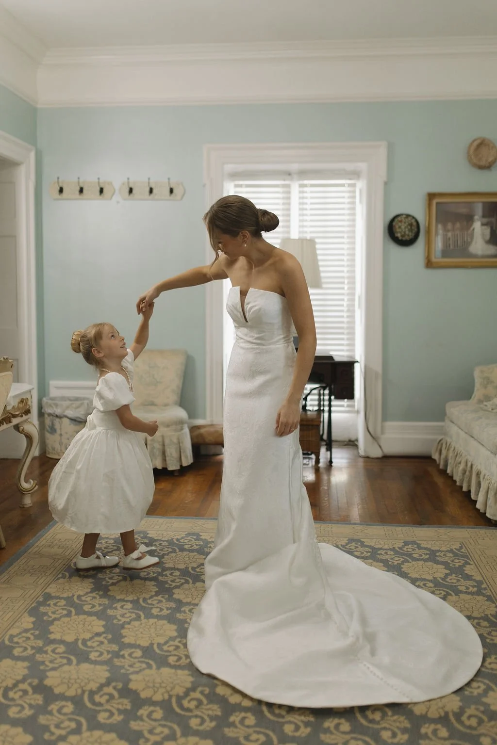 nicole-noor-by-locket-by-watters-ivory-and-beau-southern-wedding-dress-bride-and-flower-girl-dancing-adorable-wedding-photos-with-flowergirl.jpg