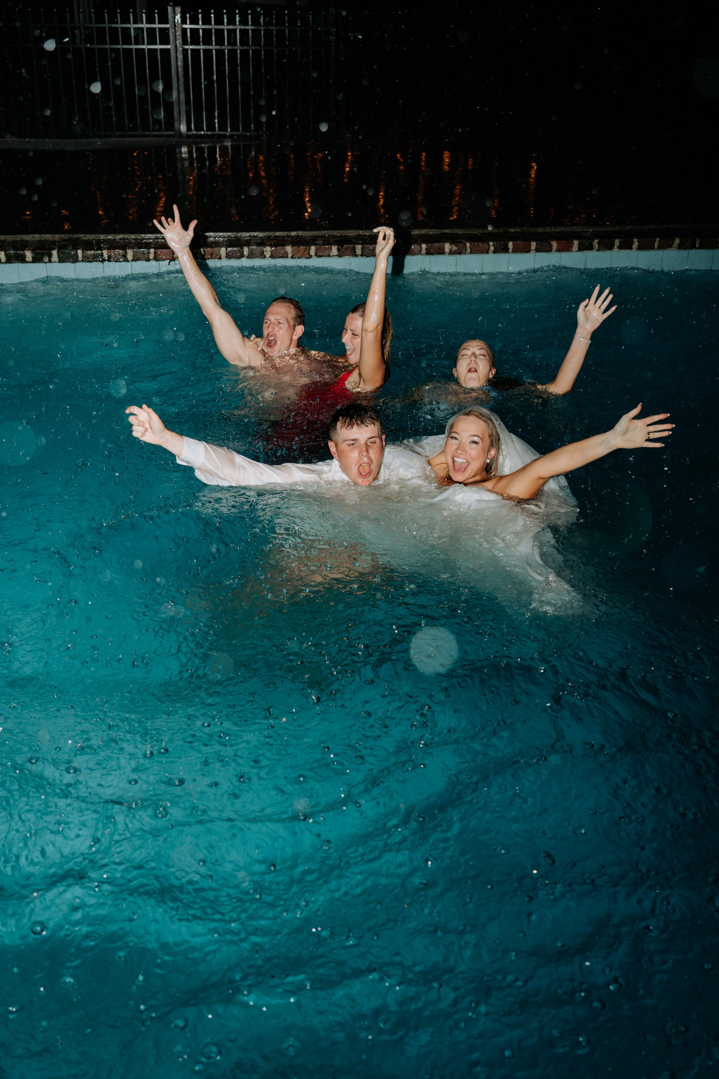 bride-and-groom-in-the-pool-afterparty-wedding.jpg