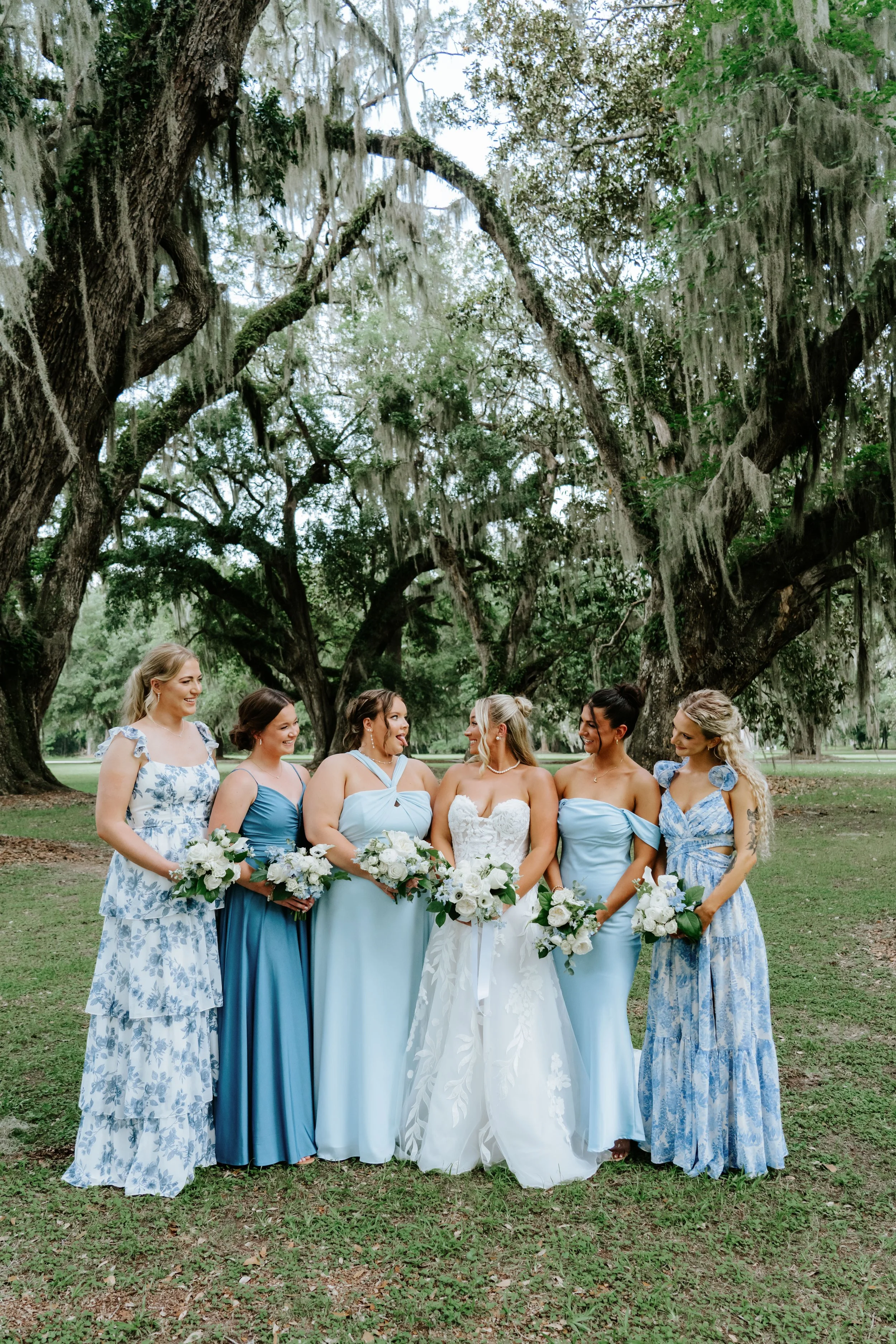 mismatching-blue-bridesmaids-dresses-cotton-hall-events-wedding-southern-wedding-inspiration-southern-bride-destin-by-sottero-and-midgley-lace-a-line-wedding-dress-ivory-and-beau.jpg