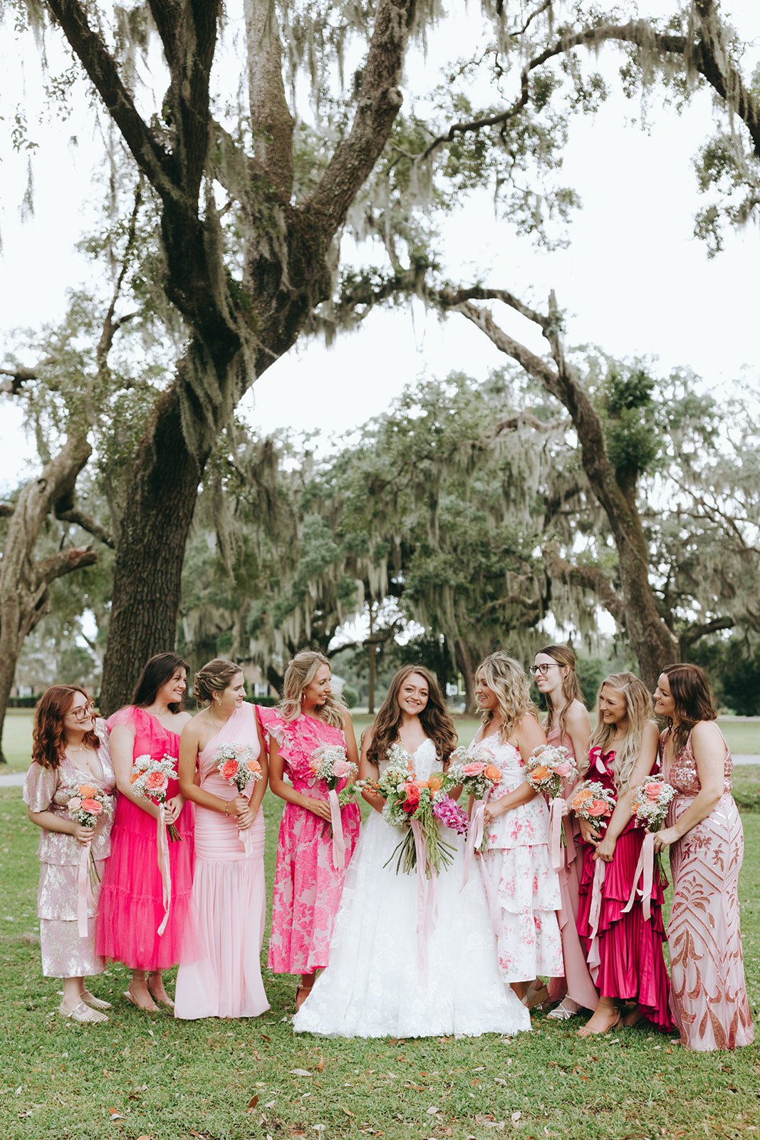 maggie sottero bride with bridesmaids in hot pink dresses.jpg