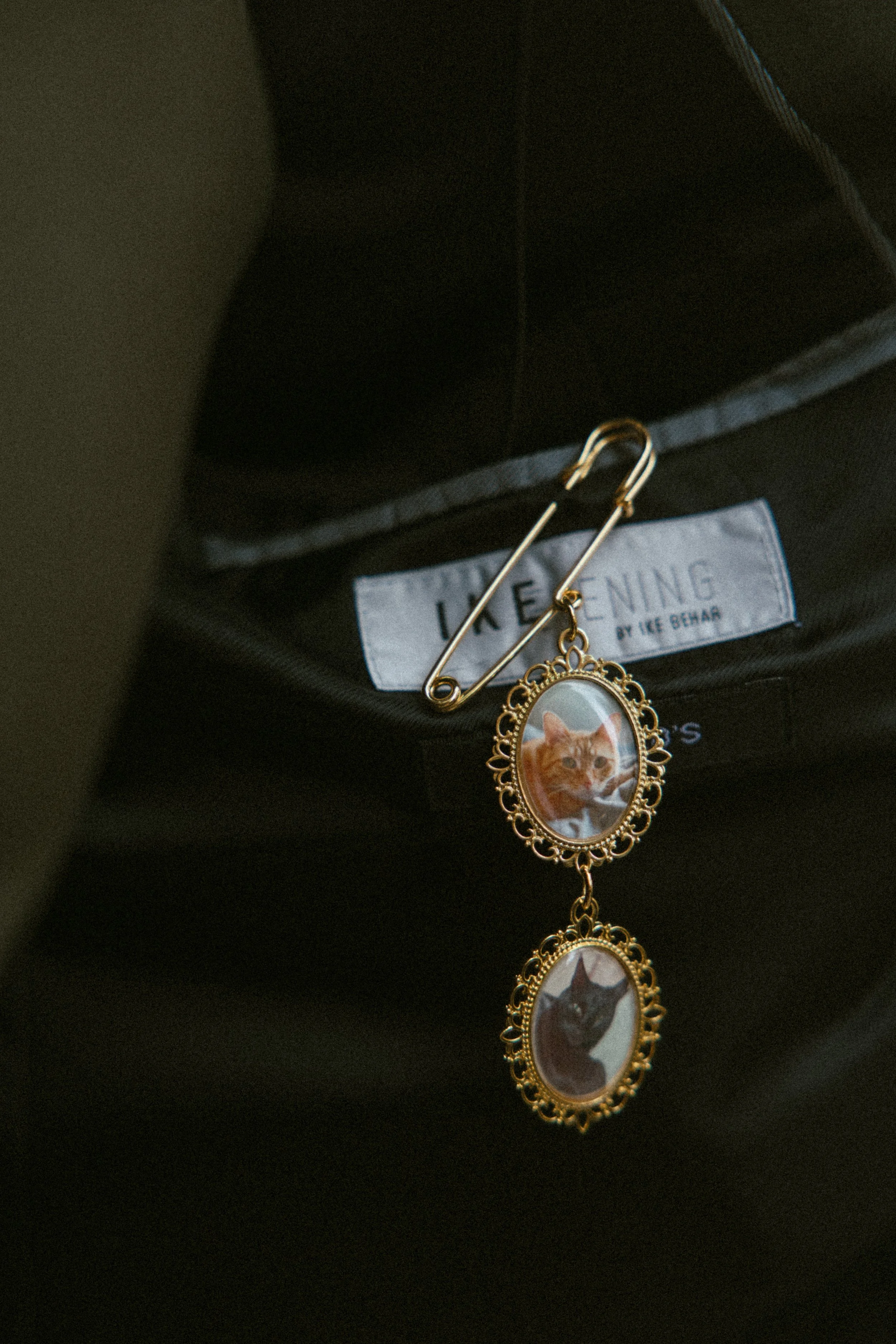 Groom’s memorial photo charms pinned inside his wedding suit jacket.