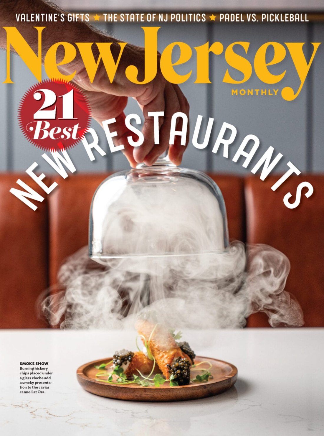 Cover of New Jersey Monthly magazine featuring a smoked hickory chips presentation under a glass cloche, with steam rising from the food, set on a white marble table.
