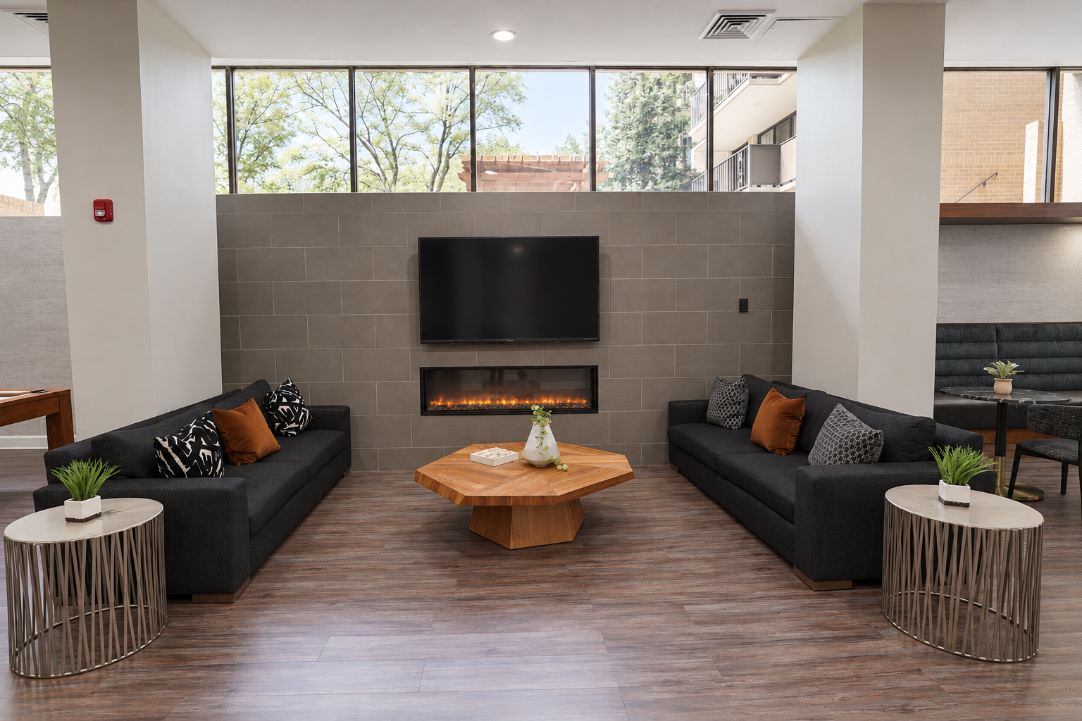 Resident Clubhouse at Westchester Tower Apartments with modern seating, a wall-mounted TV, and stylish decor, offering a bright and open space for social gatherings