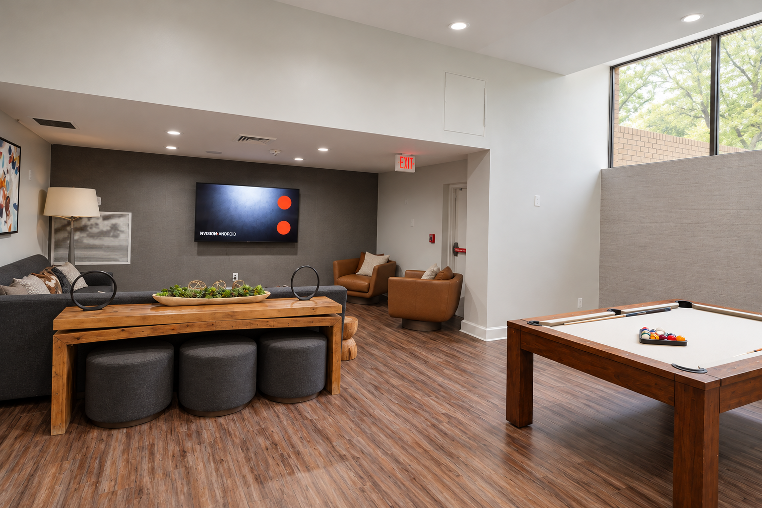 Clubhouse in Maryland with a wall-mounted TV, pool table, and stylish decor, offering a bright and open space for social gatherings