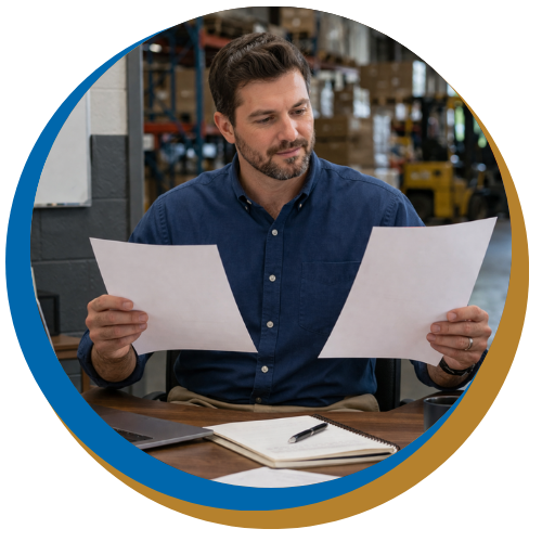 Business owner at his desk looking at documents.