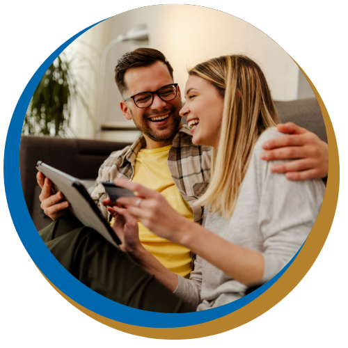 Couple sitting down reviewing finances on tablet