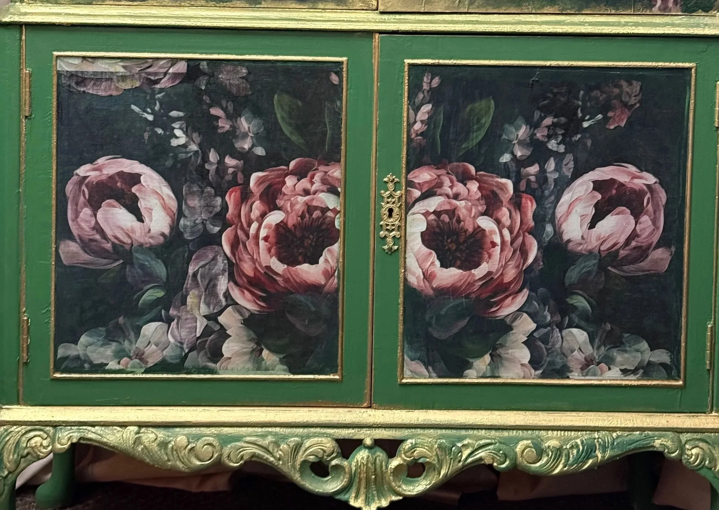 Dark romantic floral decoupage on a hand painted green double wine cabinet featuring large pink and white roses with rich botanical details