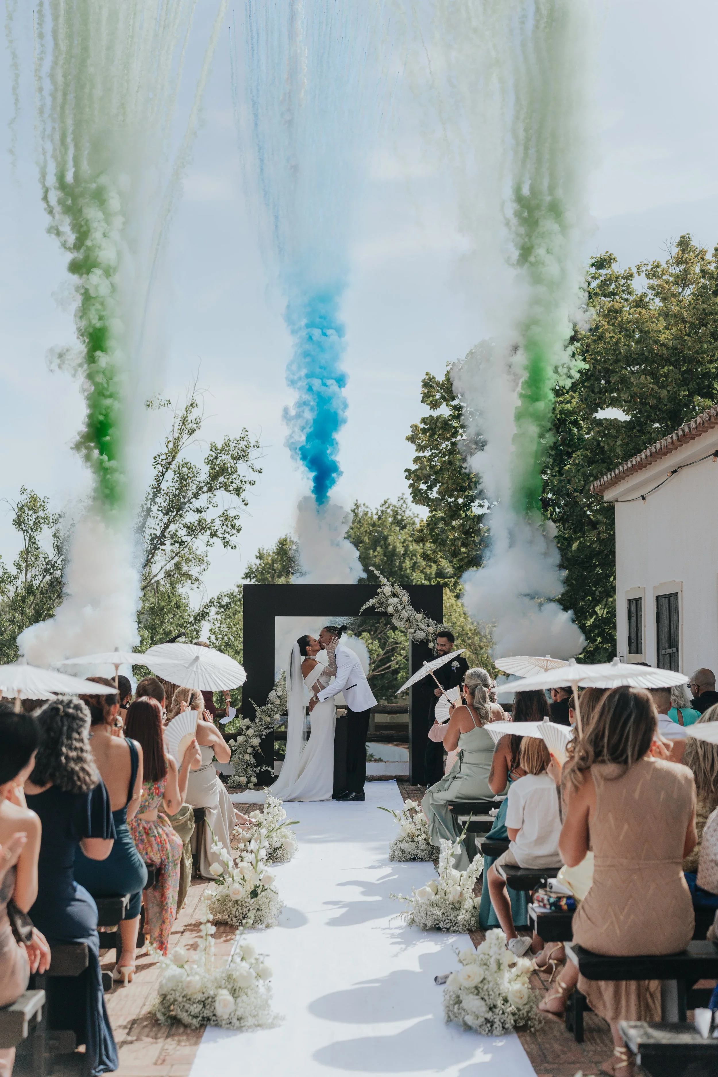 First kiss during the wedding ceremony with smoke effects in Mallorca