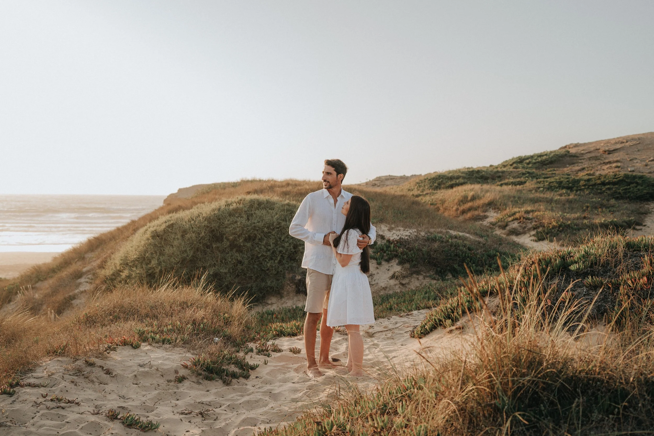 Couple enjoying the ocean view at Praia da Cordoama