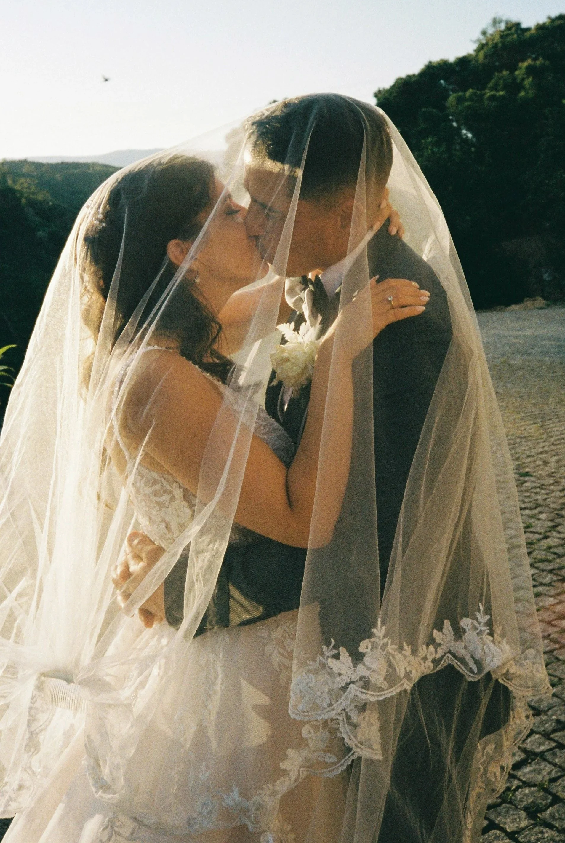 Analog wedding photo of a bride and groom kissing in the Algarve